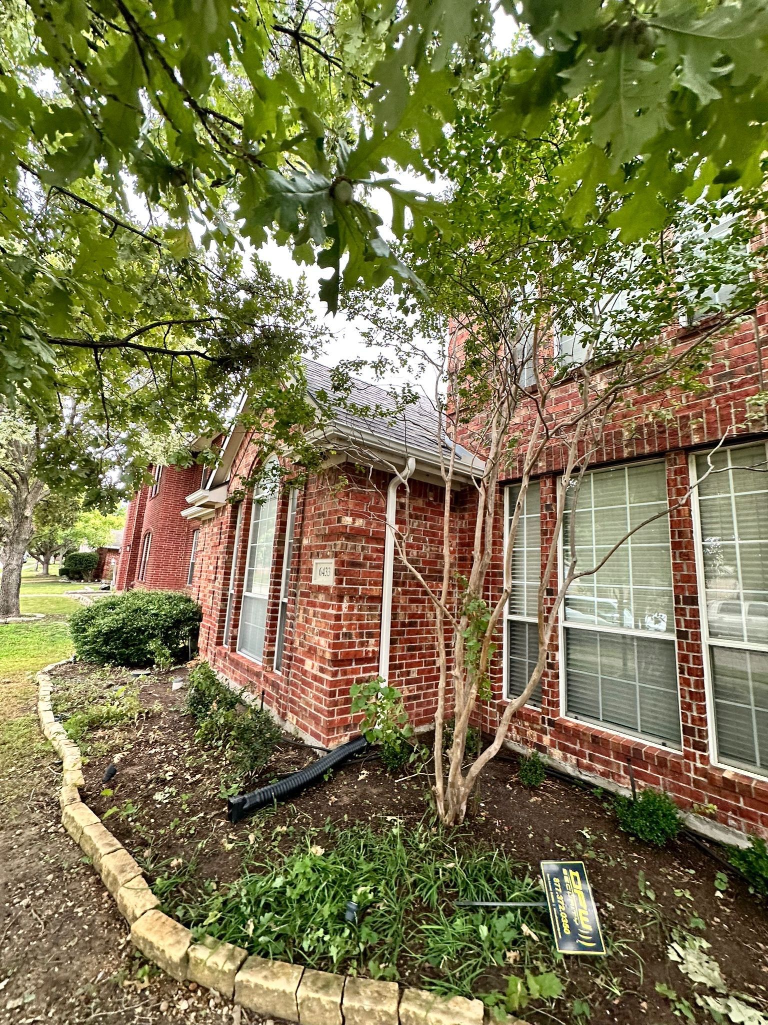 IKO Cornerstone-Dark Reddish Brown brick house  by Tejas Roofworks + Restoration