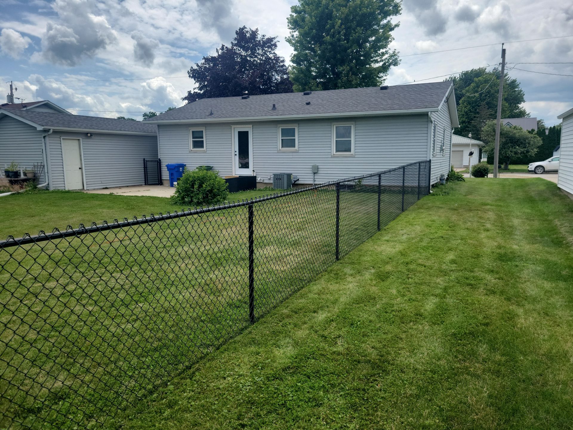 Residential Black Vinyl-Coated Chain Link Fence Installation in Allison by Perfect Picket Fence and Stain