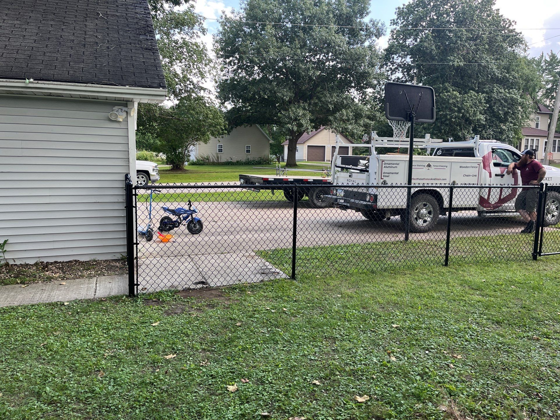 Black Chain Link Perimeter Fence and Gate Installation in Shell Rock by Perfect Picket Fence and Stain