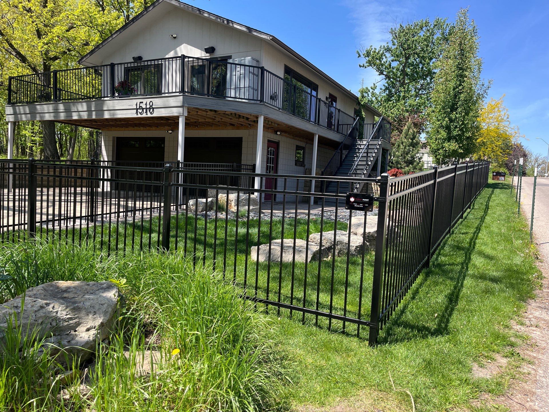 Ornamental Black Metal Picket Fence Installation in Cedar Falls by Perfect Picket Fence and Stain