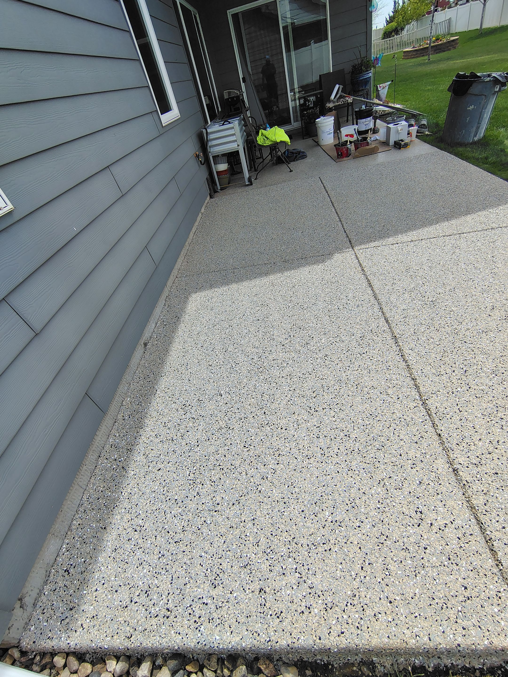 Speckled Concrete Patio Coating Installation in Sioux Falls by Select Painting, Coatings & Garage Cabinets