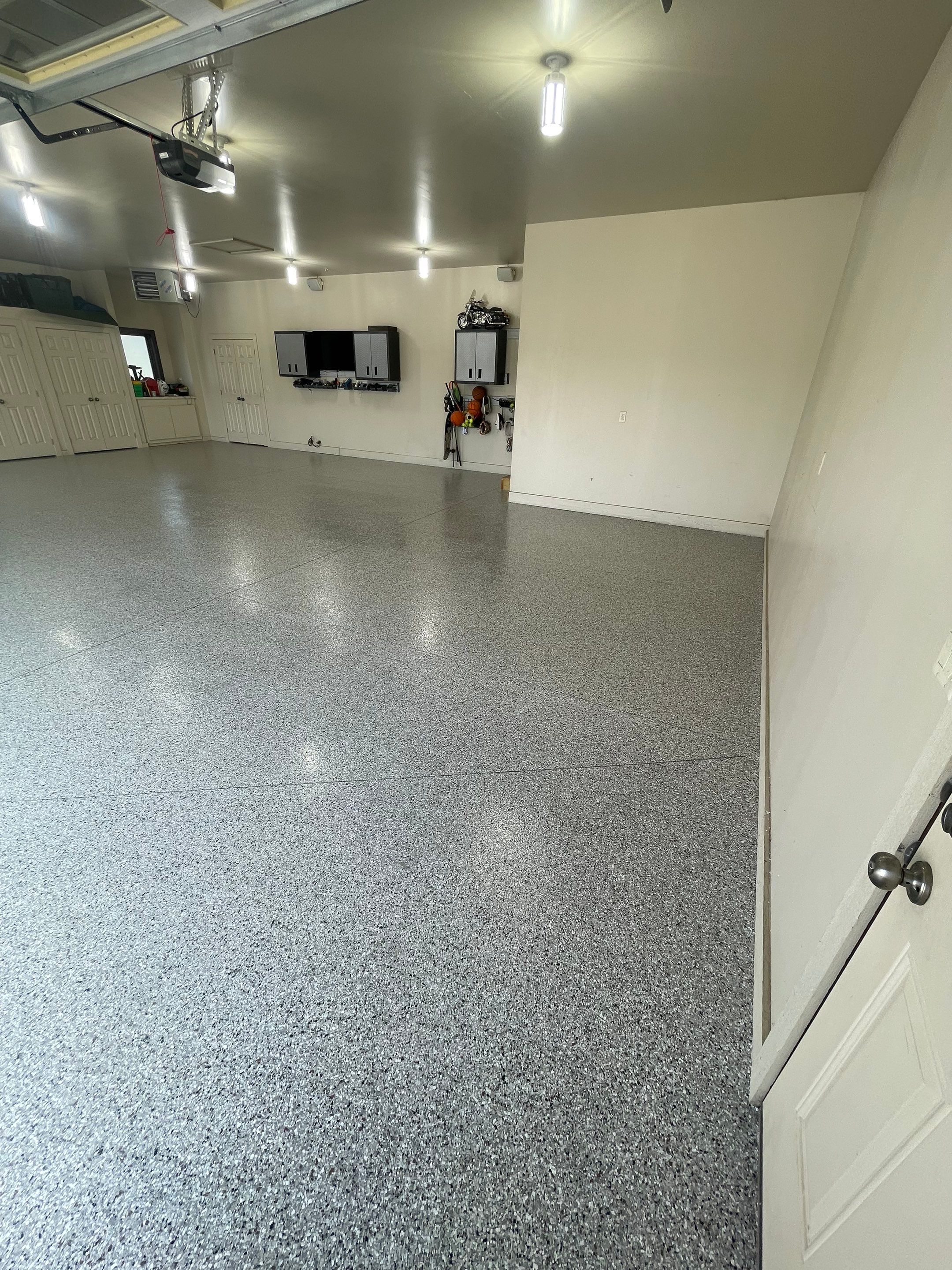 Coyote Flake Garage Floor Coating in Sioux Falls with Trench Drain by Select Painting, Coatings & Garage Cabinets