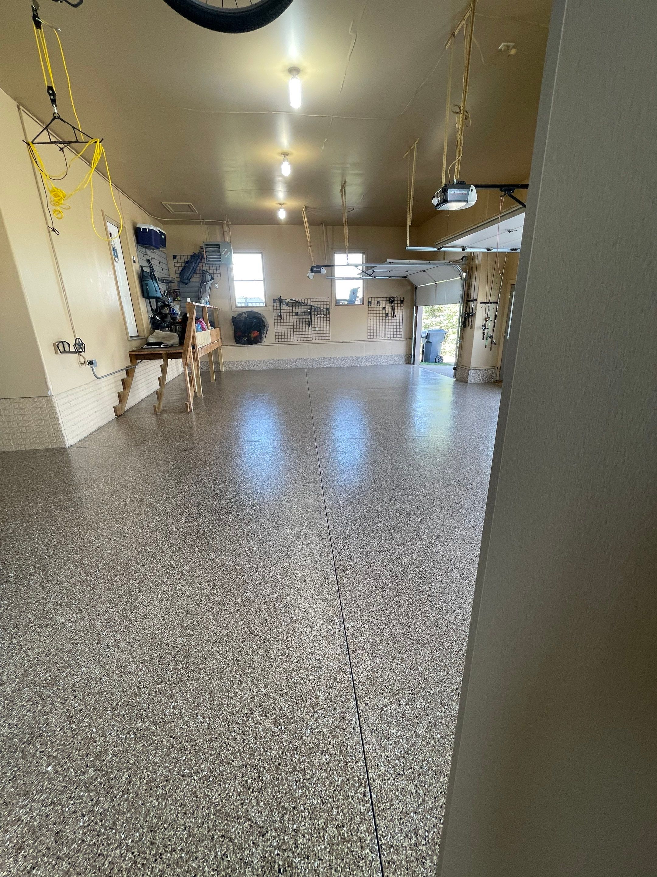 Residential Garage Floor Transformation with Speckled Epoxy Coating by Select Painting, Coatings & Garage Cabinets