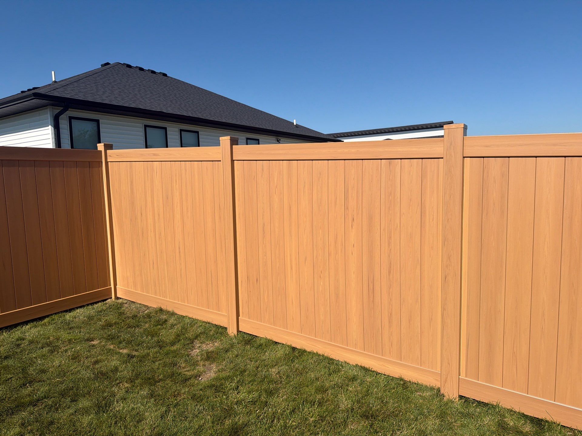 Residential Cypress Vinyl Privacy Fence Installation in Cedar Falls by Perfect Picket Fence and Stain