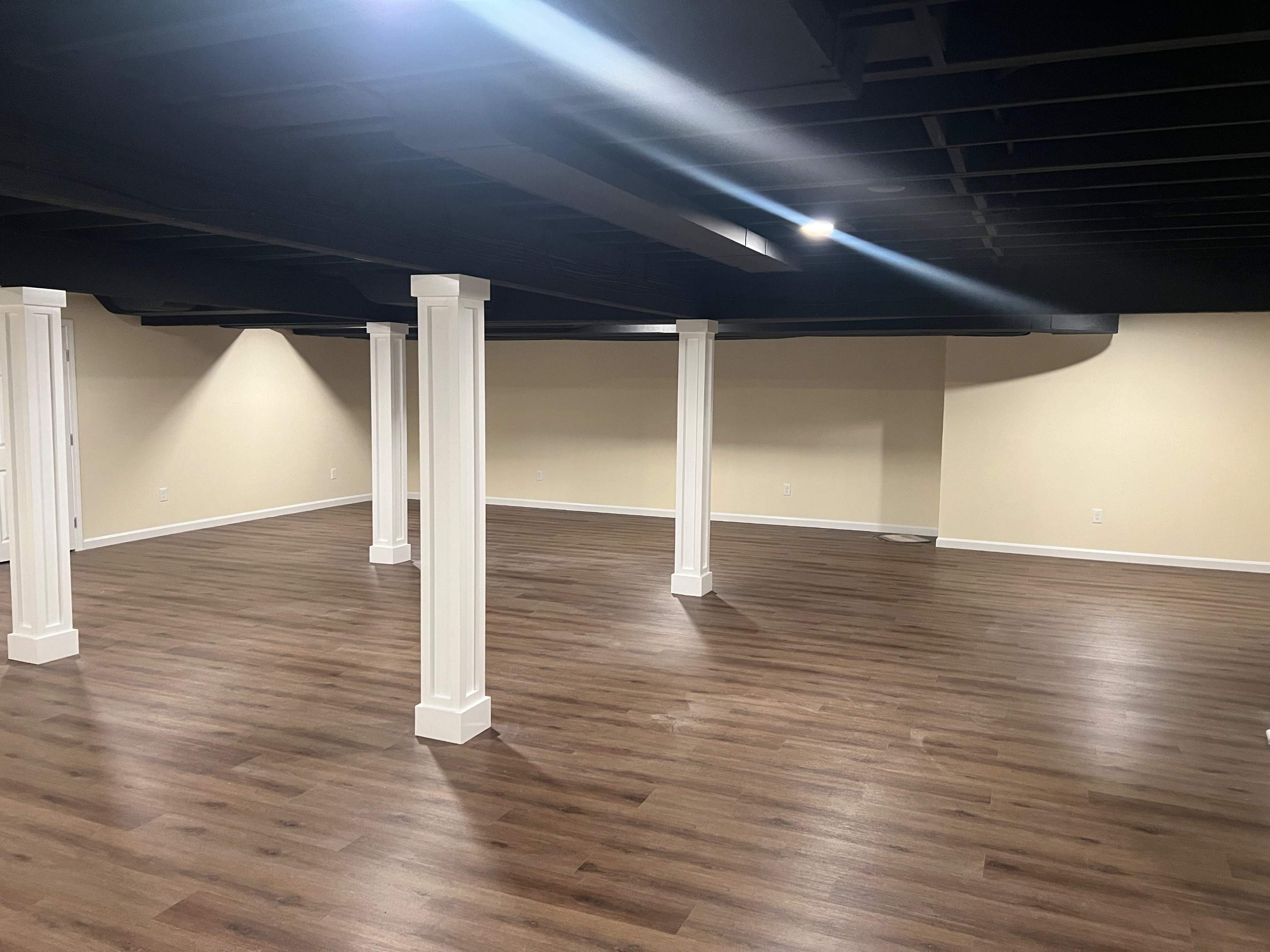 Basement Remodel w/ LVP Flooring & Exposed Ceiling by Chagnon Building & Remodeling LLC