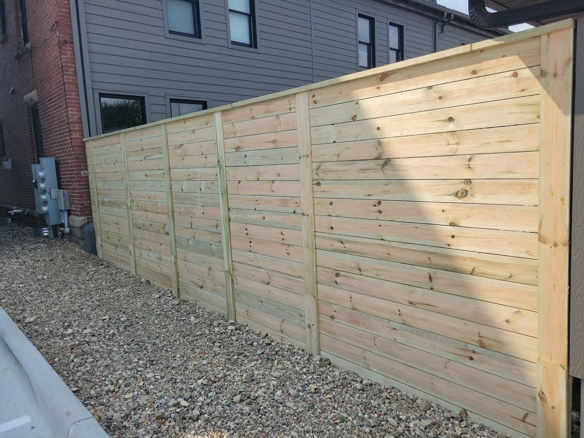 Modern Horizontal Slat Wood Privacy Fence Installation in Cedar Falls by Perfect Picket Fence and Stain