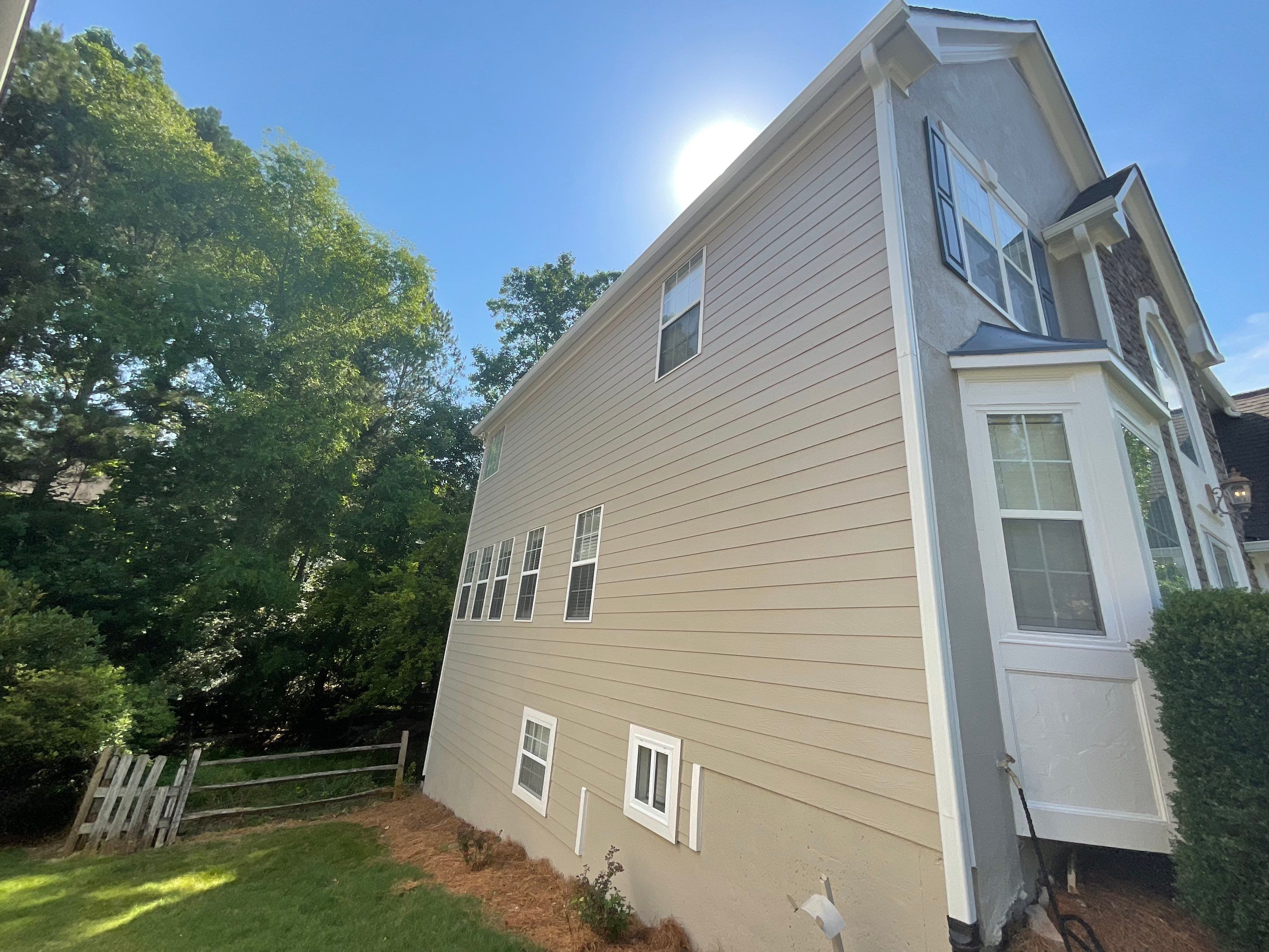 Stucco and Siding Exterior Painting with New Gutters in Kennesaw by Swift Home Renovations