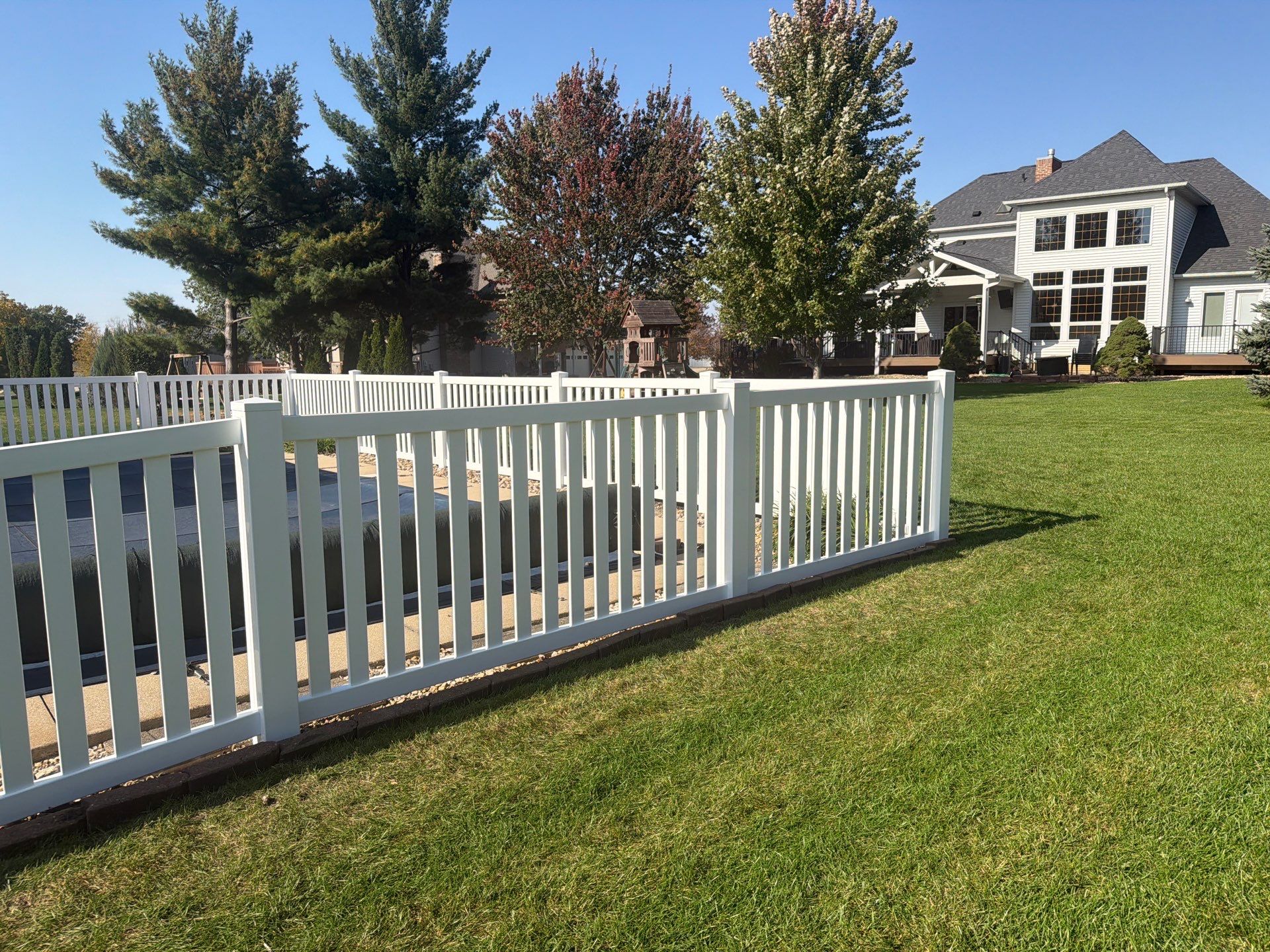 White Vinyl Picket Pool Fence Installation in Waterloo, Iowa by Perfect Picket Fence and Stain