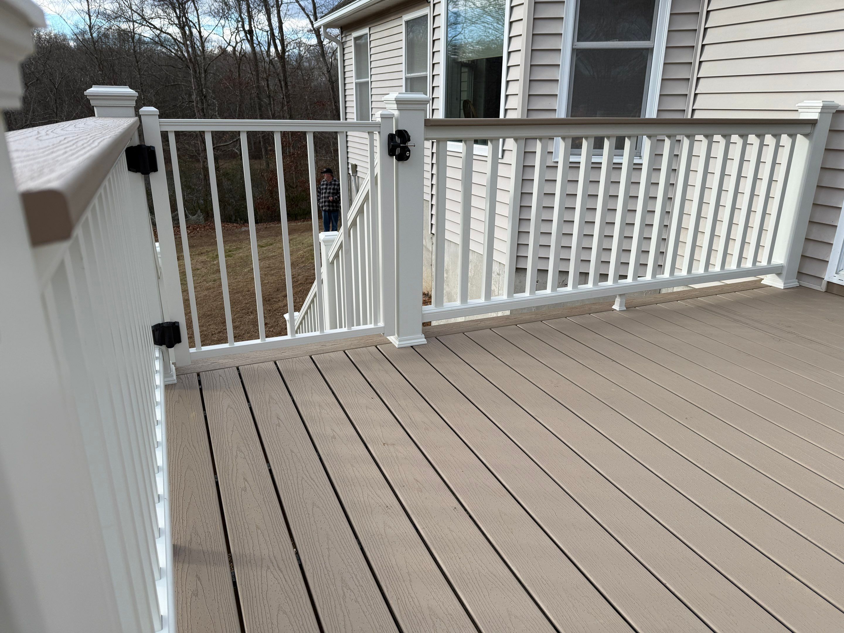 Replacement deck using Trex Transcend Ropeswing and White Transcend railings, with gate by DiGiorgi Roofing and Siding Inc