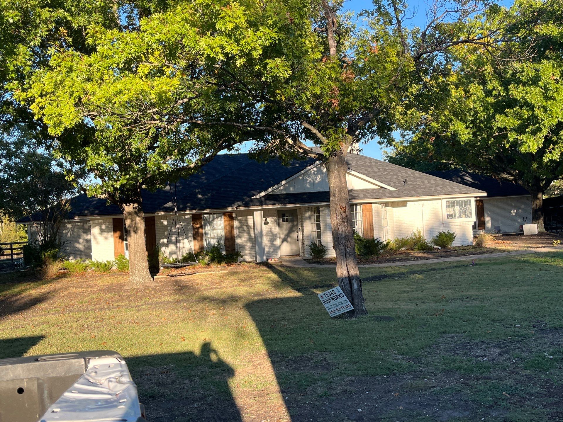 White brick with IKO Granite Black by Tejas Roofworks + Restoration