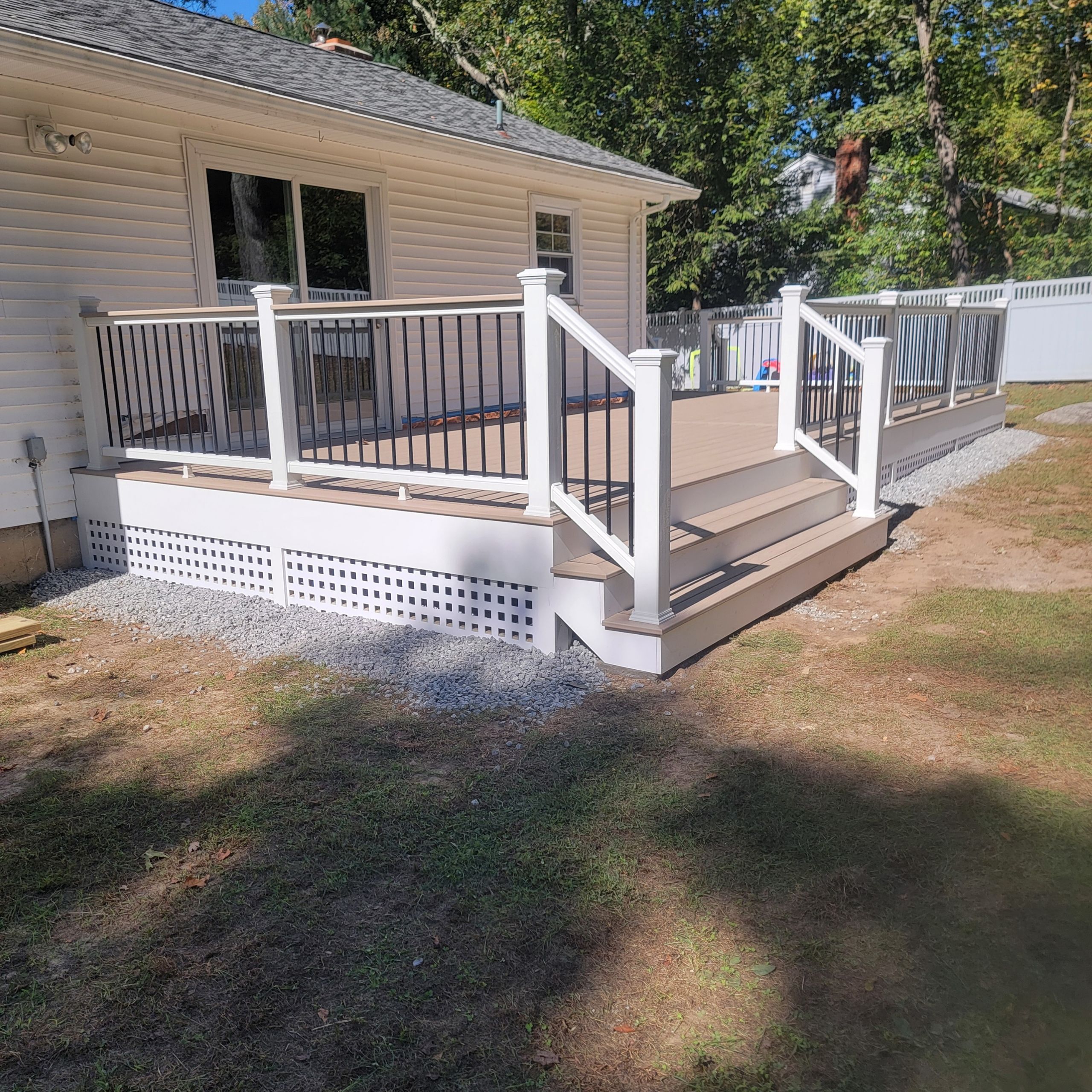 Deck replacement using Trex Transcend Rope swing and Transcend cocktail rail and trex lattice  by DiGiorgi Roofing and Siding Inc