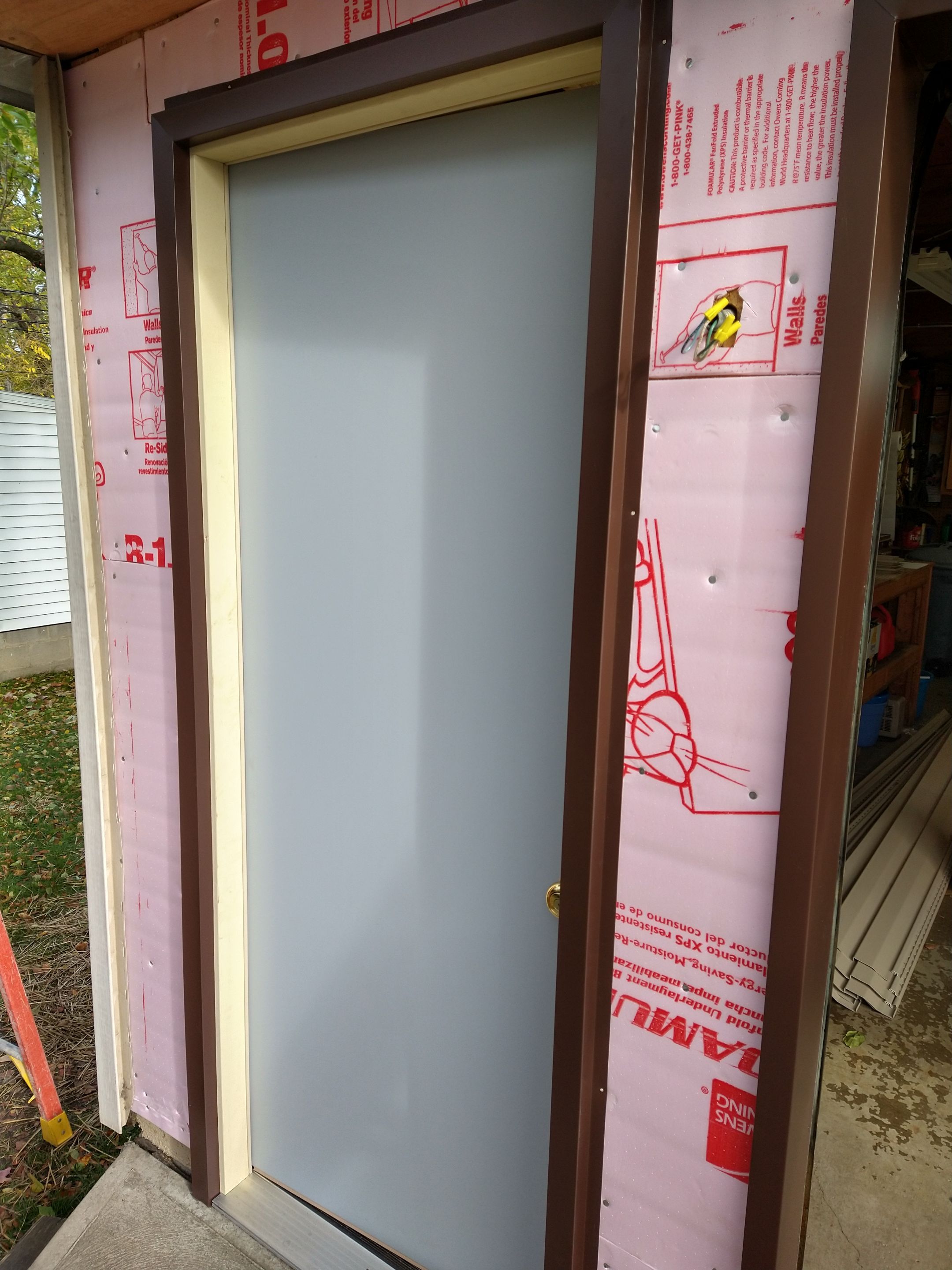 Siding Installation using Norandex woodsman dl-5 white woodgrain vinyl by Absolute Roofing and Construction