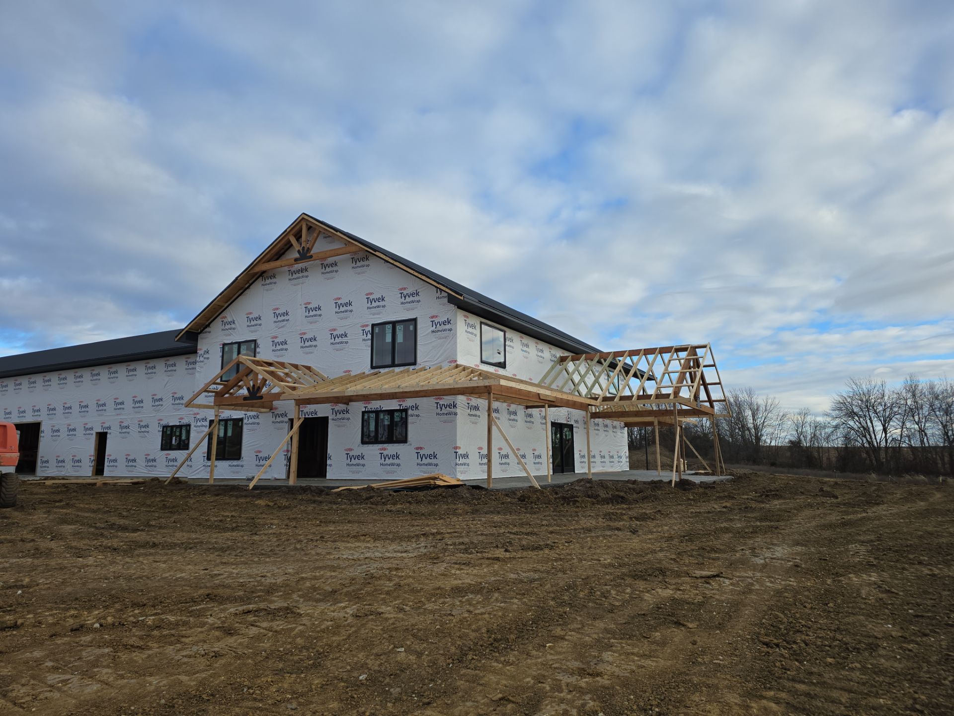 New Home construction w/ board and batten sides and metal roof  by Miles Construction 