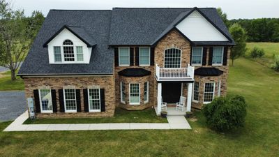 Roof Damage using Certainteed Lifetime Roofing System- Moire Black Landmark Pro shingkes with shadow ridge caps.