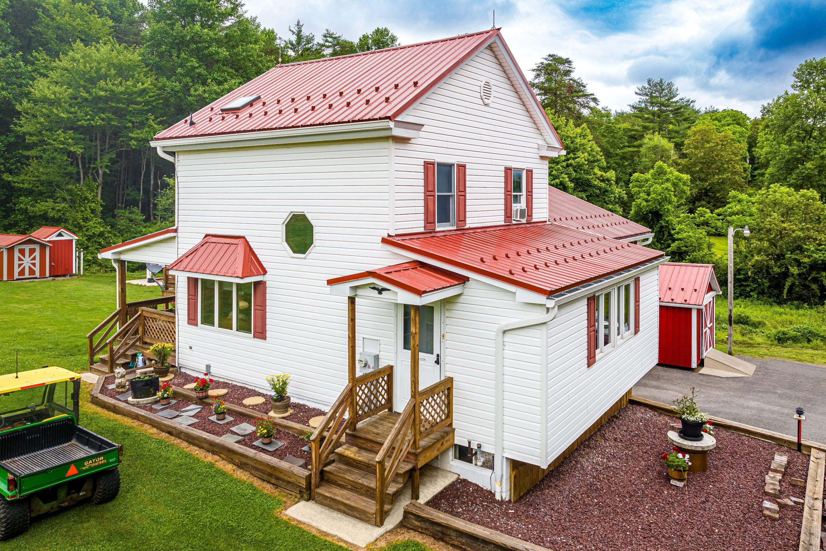 Metal roof -barn red, and New garage by Esh Builders
