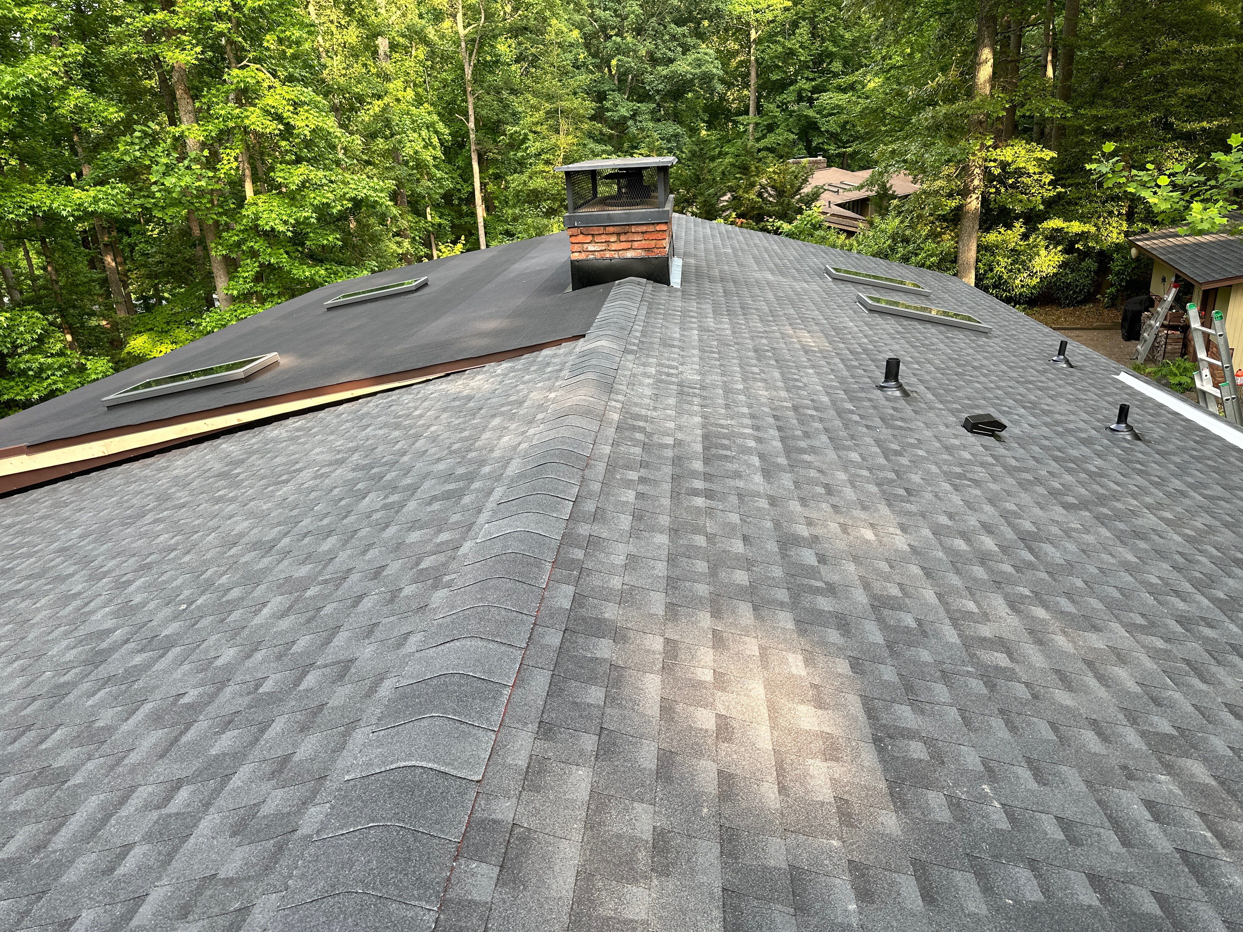 Acorn Deck House Roof Replacement + Skylight Addition by American Home Contractors