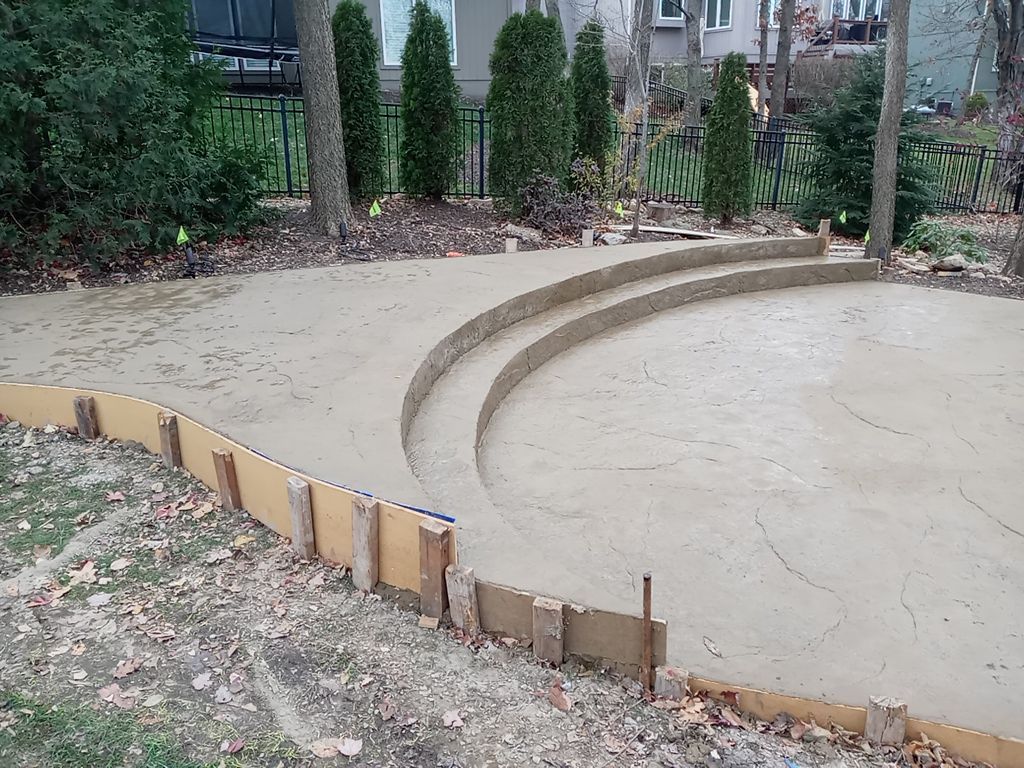 Back Yard Alpine Stamped Patio by LAND ESCAPES LLC