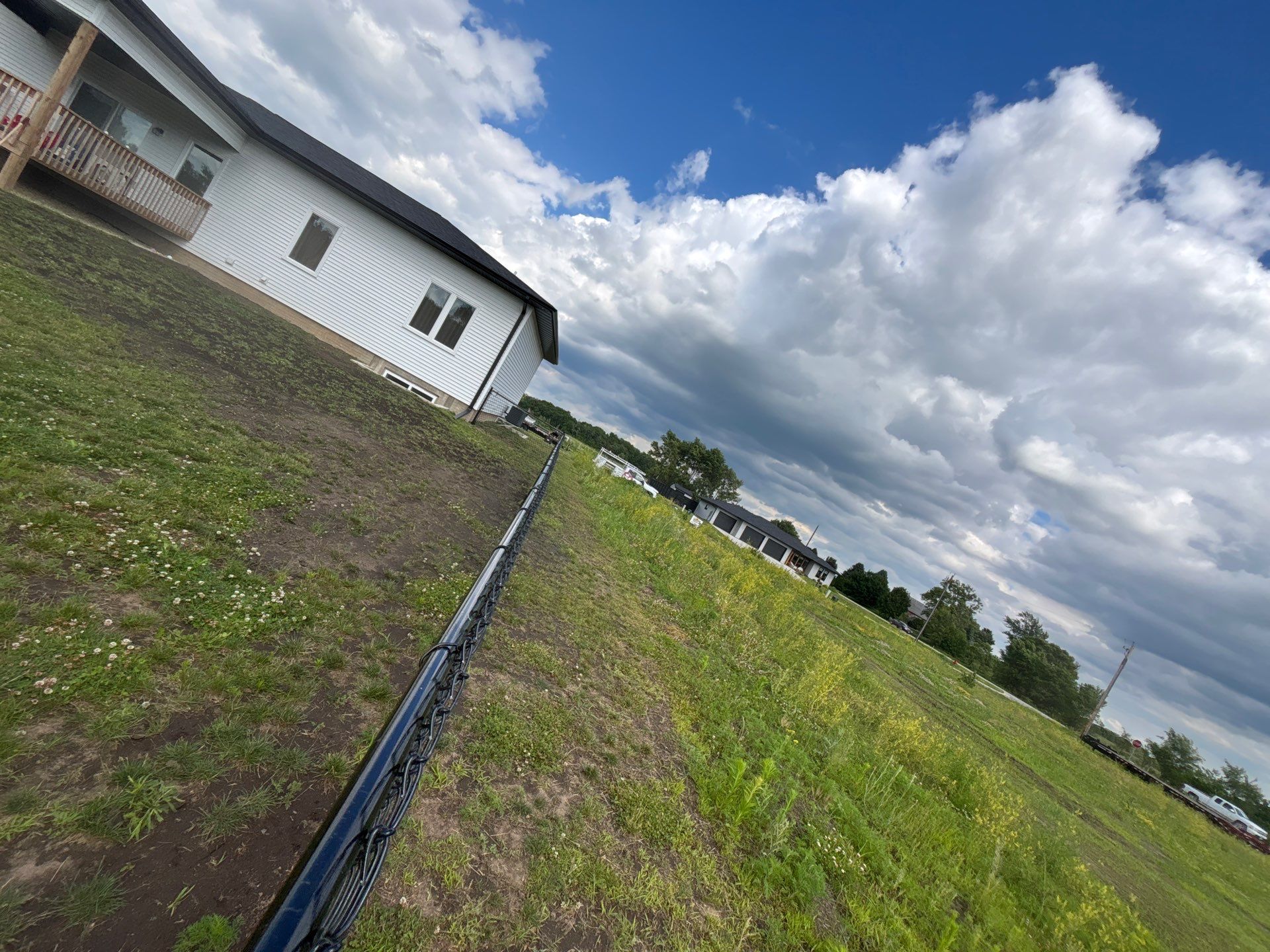 Black Vinyl-Coated Chain Link Fence and Residential Site Grading by Perfect Picket Fence and Stain