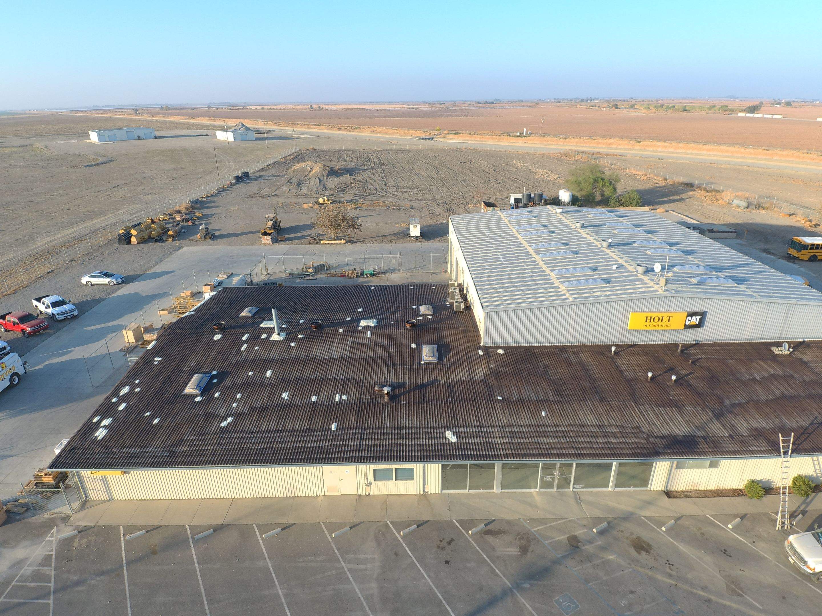 Metal roof restoration on commercial roof using Conklin Benchmark/ PUMA XL acrylic coatings over metal and foam by Straight Edge Roofing Inc