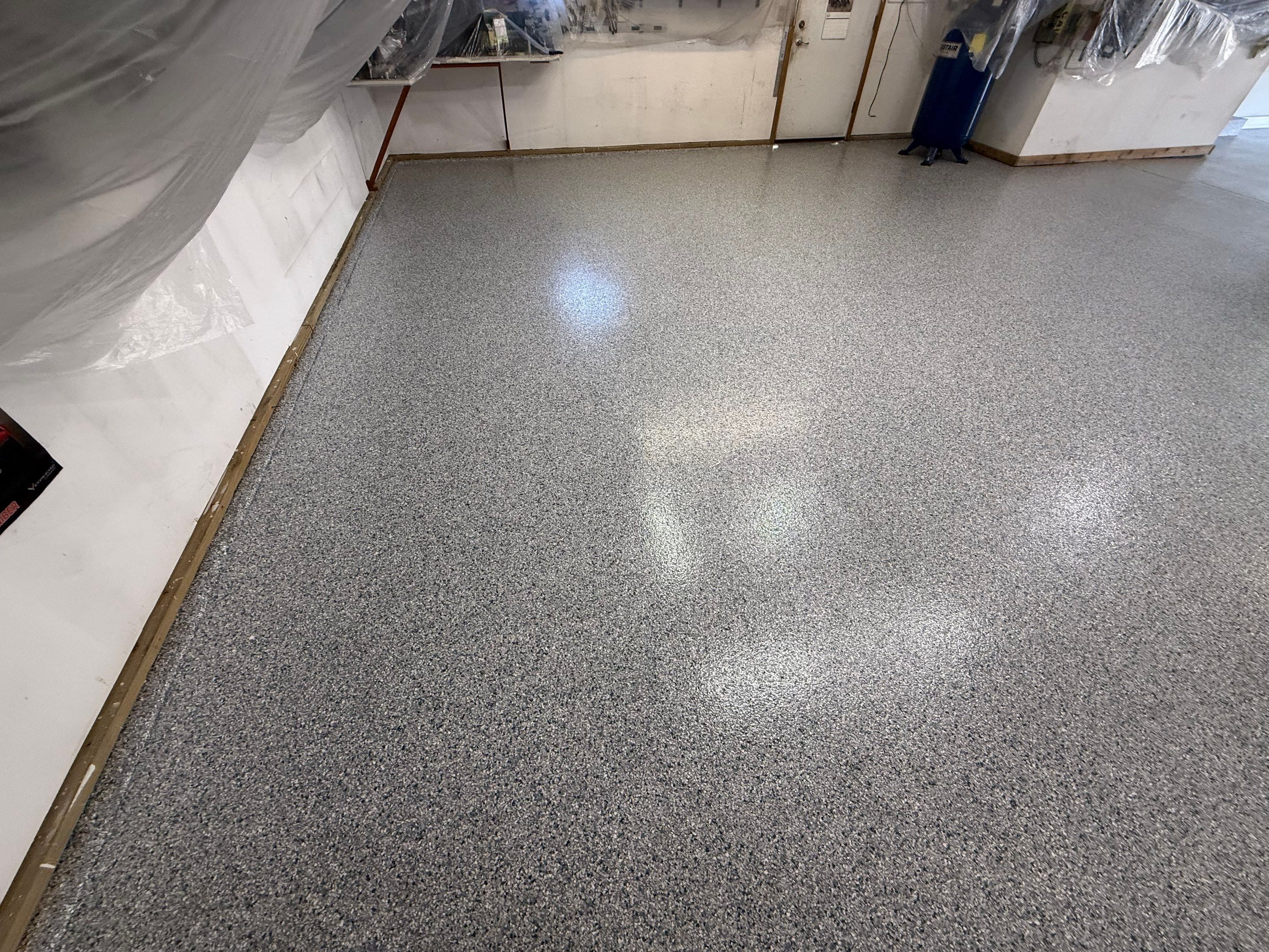High-Performance Polyurea Garage Floor Coating and Stem Wall Finishing in Sioux Falls by Select Painting, Coatings & Garage Cabinets