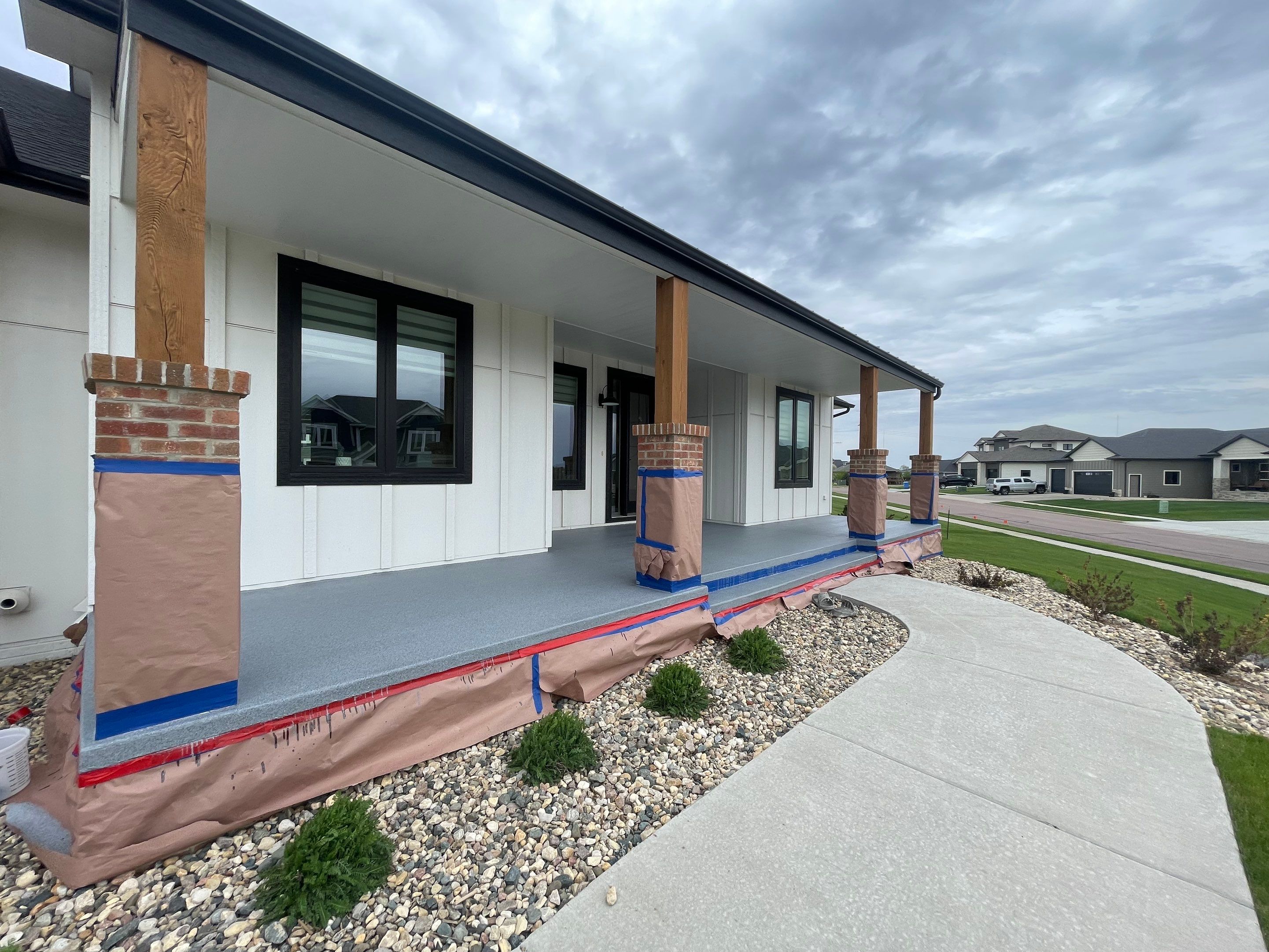 Grey Speckled Concrete Porch Coating for Sioux Falls Home by Select Painting, Coatings & Garage Cabinets