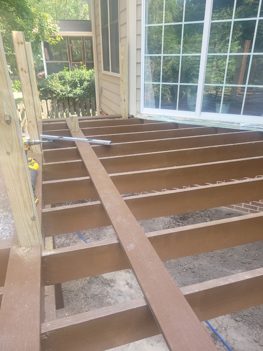 Fuquay-Varina Outdoor Upgrade – Composite Deck & Paved Landing by Elite Remodeling and Design LLC