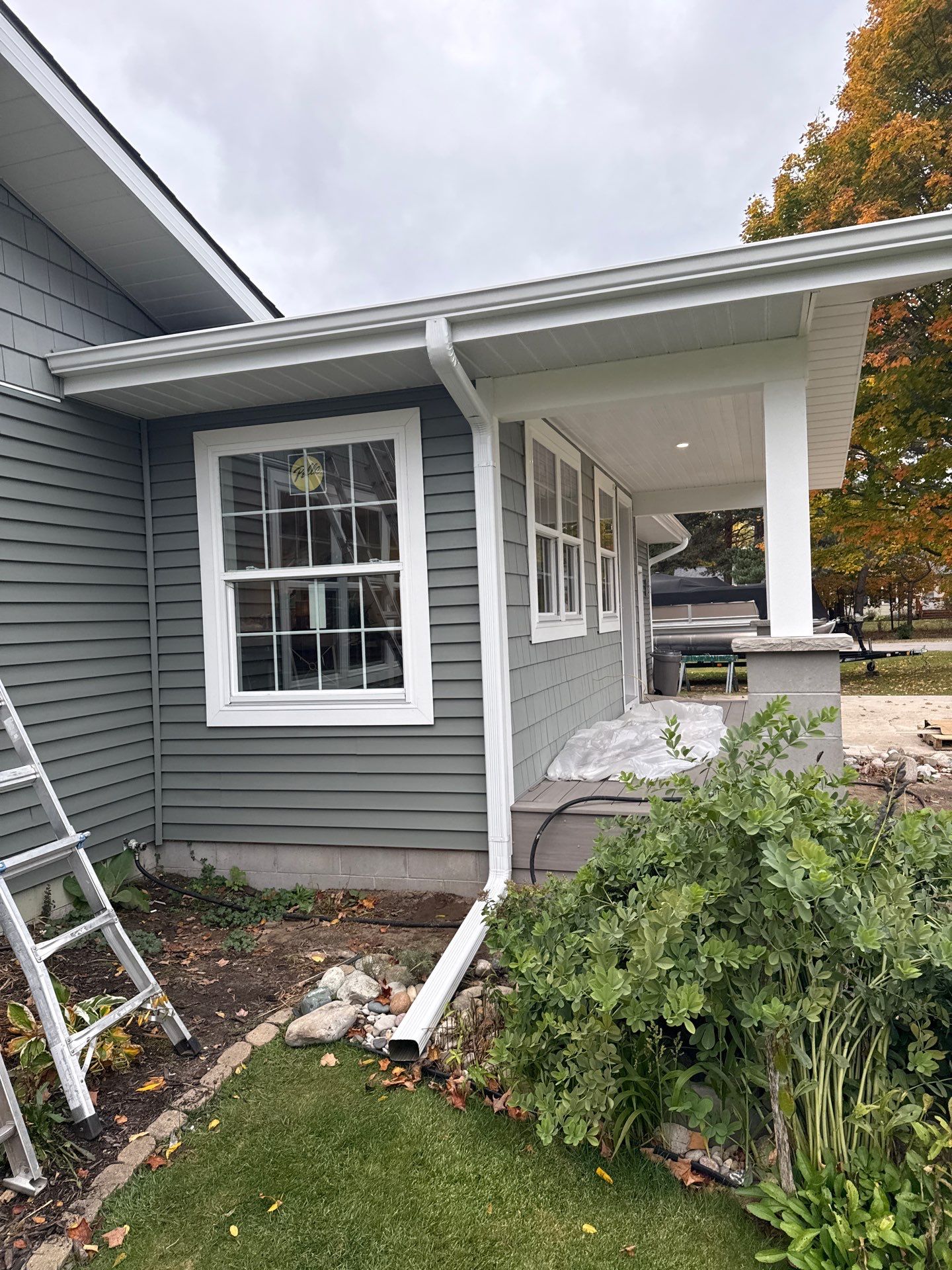 New Aluminum Gutters and White Downspouts for Traverse City Home by Rainbow Seamless Systems