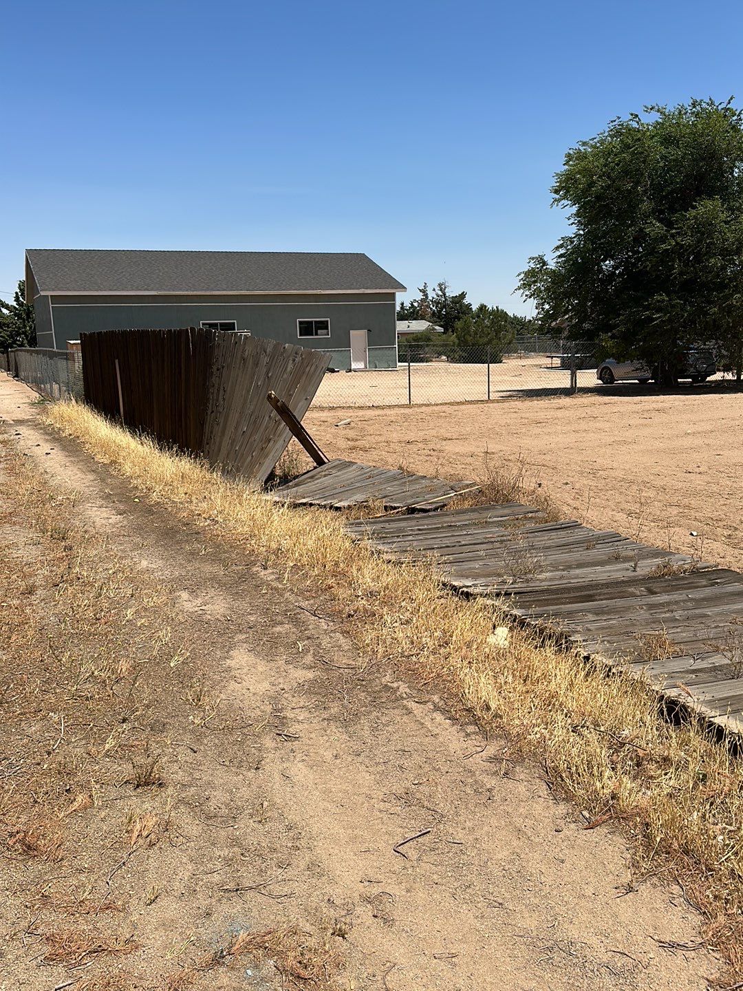 Replaced wood fence with chain link fence.  by Fence Guys Inc. 