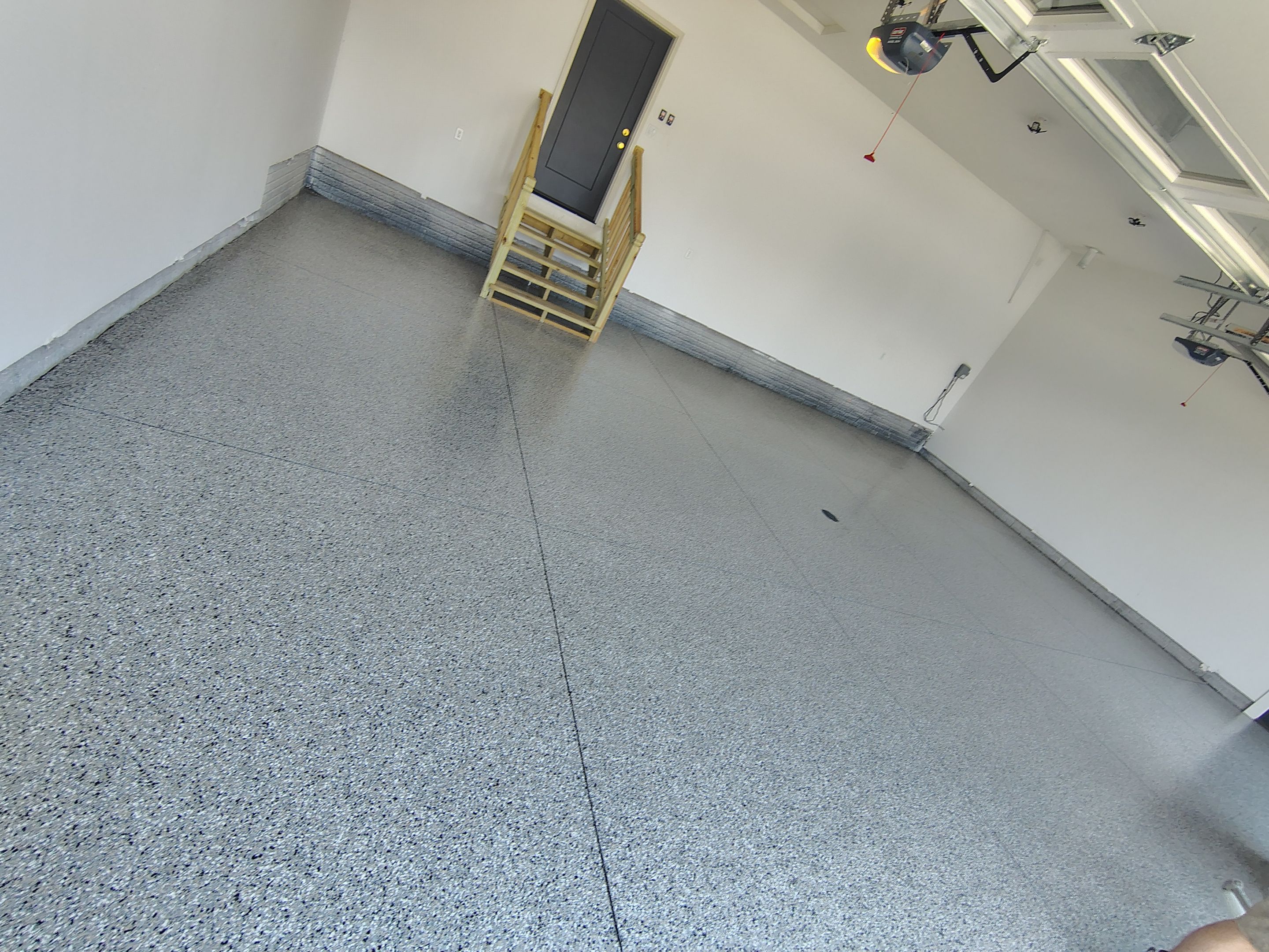 Cabin Fever Decorative Flake Garage Floor Coating in Sioux Falls by Select Painting, Coatings & Garage Cabinets
