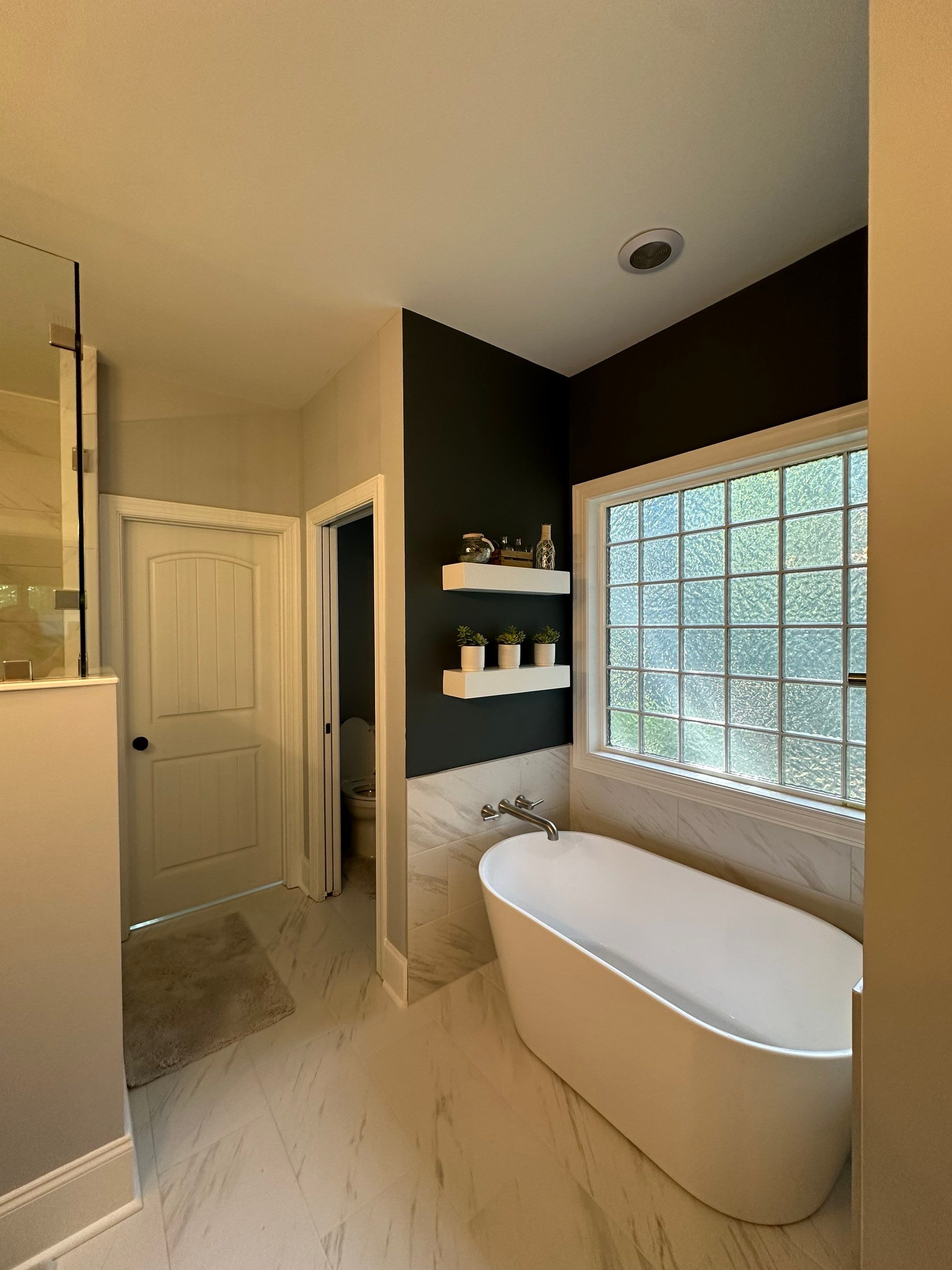 Bright Bathroom Remodel with Wall Removal, Stand Alone Tub and New Vanity by Footprints Floors of Coastal Carolina