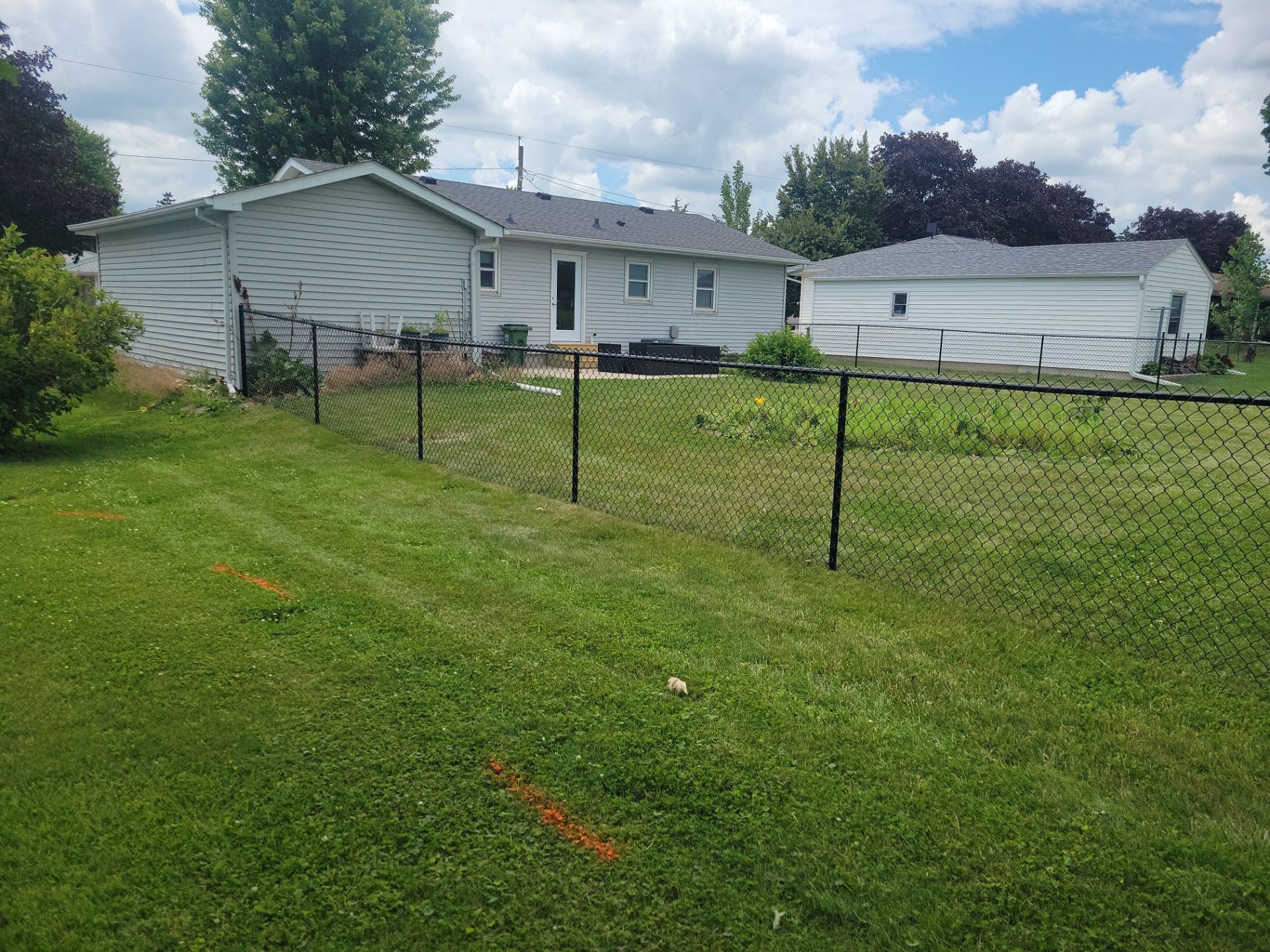 Residential Black Vinyl-Coated Chain Link Fence Installation in Allison by Perfect Picket Fence and Stain