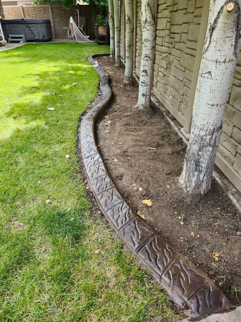 Decorative Stamped Concrete Landscape Edging Installation in Medicine Hat by Pump it Up Concrete Jacking