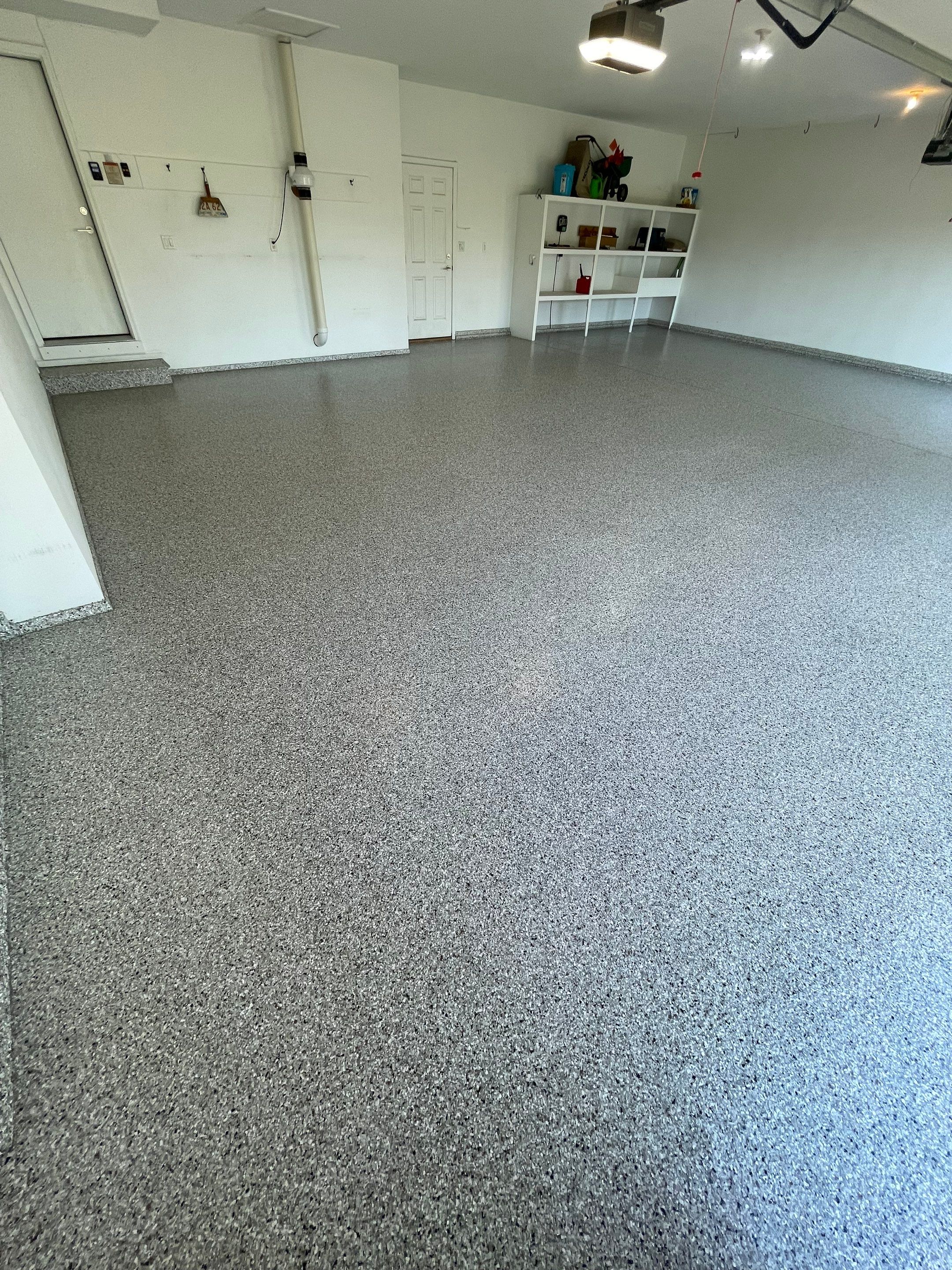 Yankton Garage Floor Restoration with Gray Speckled Epoxy Coating by Select Painting, Coatings & Garage Cabinets