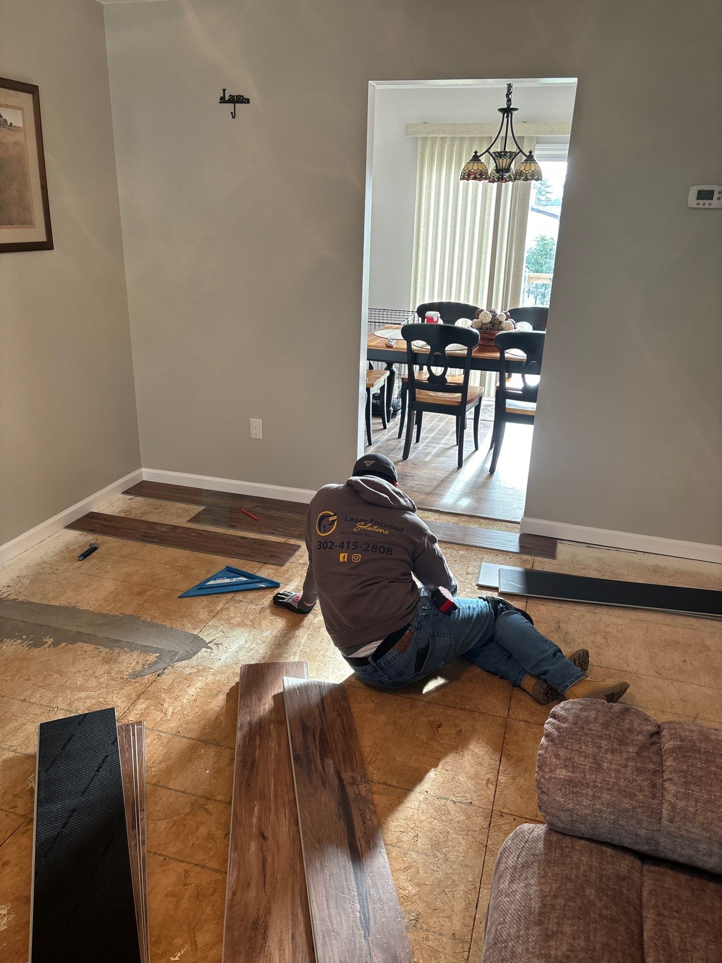 Living room LVP Flooring install  by Laser Focused Solutions LLC
