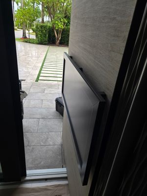This stunning custom pivot door is a true statement of security and luxury, installed in the heart of Boca Raton. Designed to withstand the harshest conditions, it is hurricane-certified, ensuring unparalleled strength and protection.  The door features a bespoke metal finish, exuding modern elegance while complementing the surrounding architecture. A custom metal door handle enhances its unique aesthetic, blending seamlessly with the door’s bold presence.  Beyond its striking appearance, this door is equipped with advanced security technology, including a motorized lock for effortless access control and a self-closing feature for seamless functionality.  A masterpiece of craftsmanship and innovation, this installation embodies the perfect fusion of security, design, and cutting-edge automation—a true reflection of FBS’s commitment to excellence.