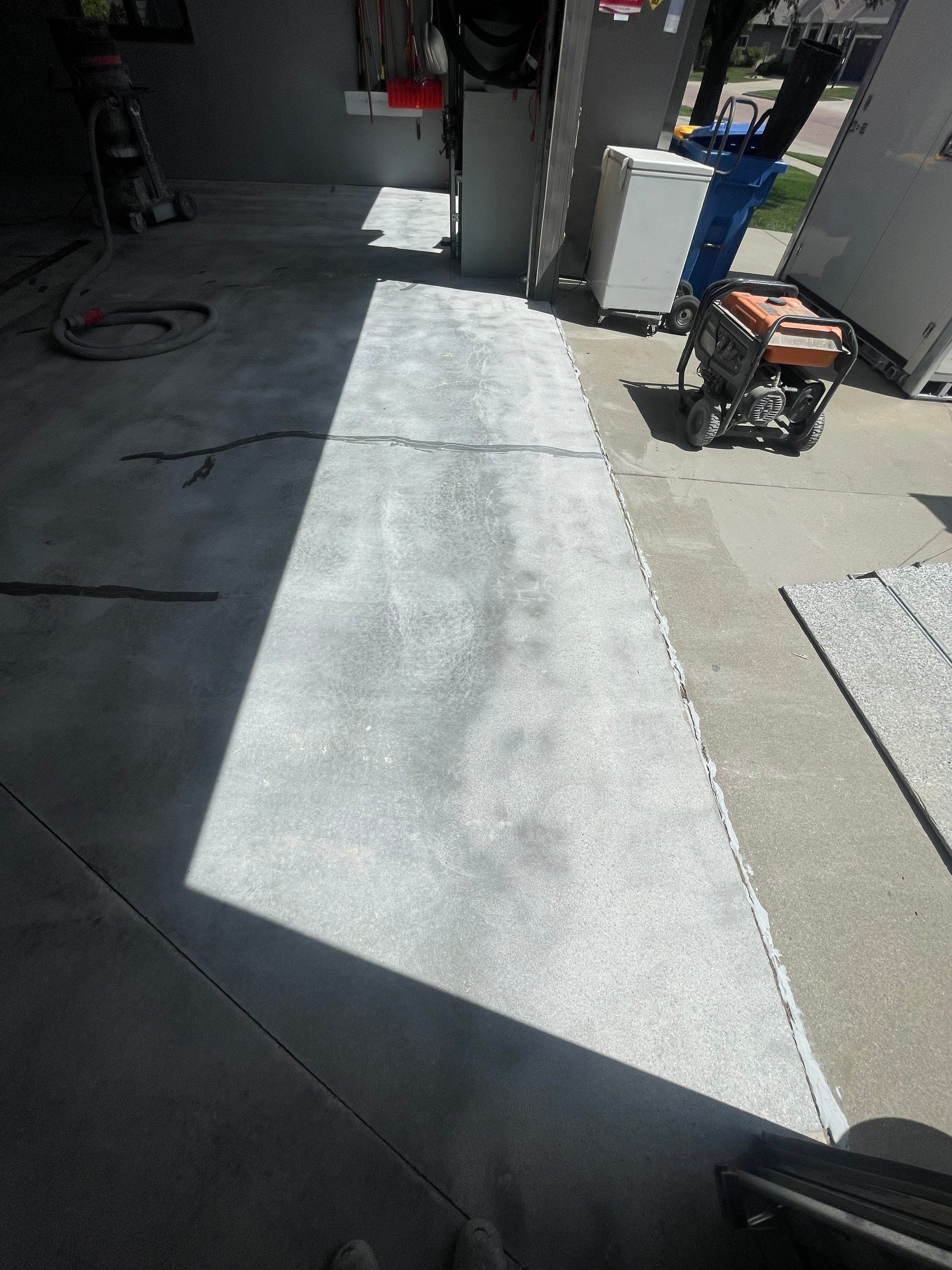 Full Garage Floor Epoxy Coating Installation in Dell Rapids by Select Painting, Coatings & Garage Cabinets