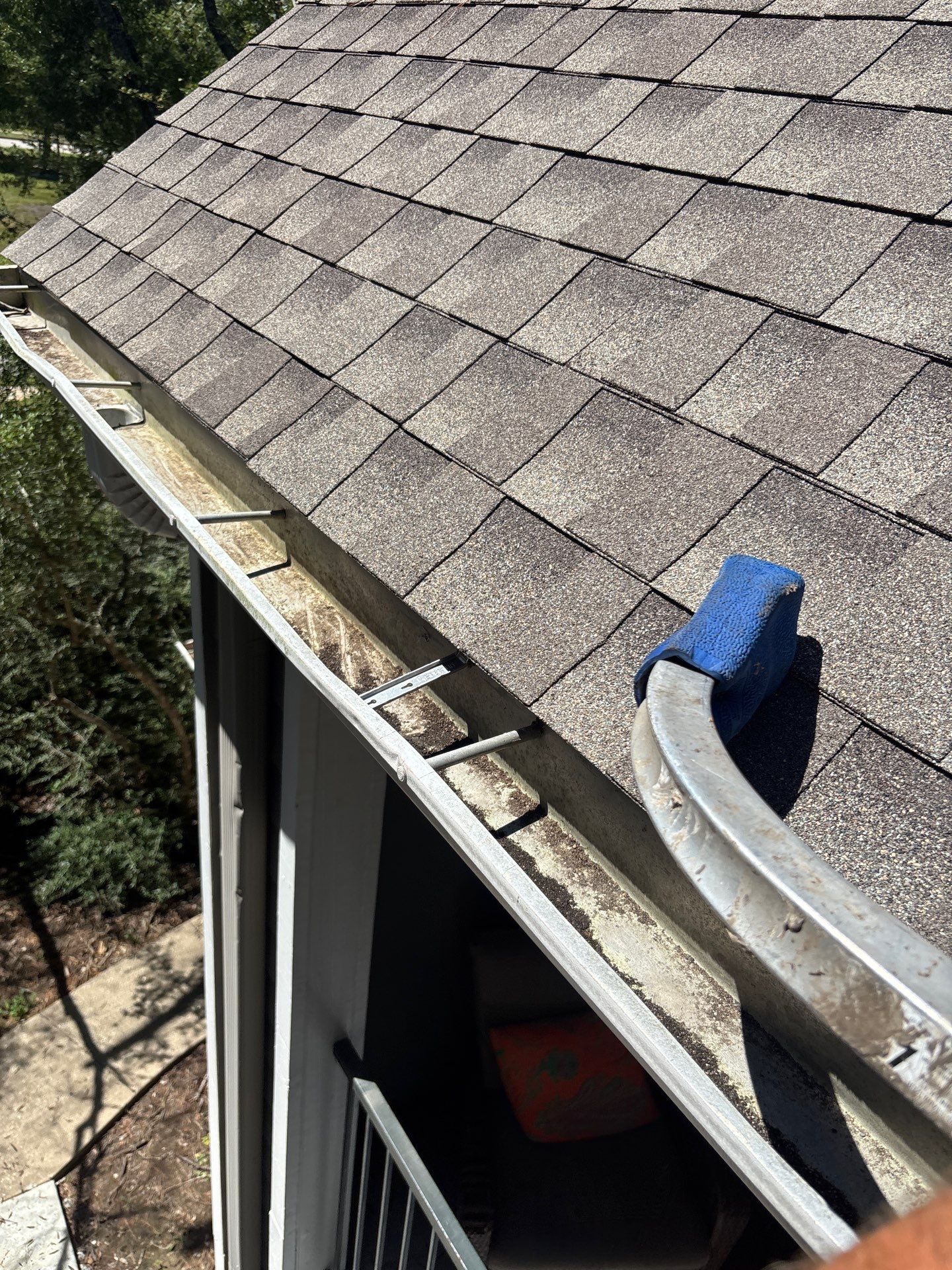 HOA gutter cleaning in Pearland, TX, after  photo showing full gutters.