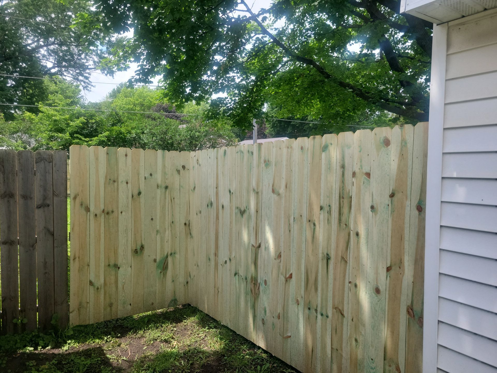Pressure-Treated Wood Privacy Fence Installation in Charles City by Perfect Picket Fence and Stain