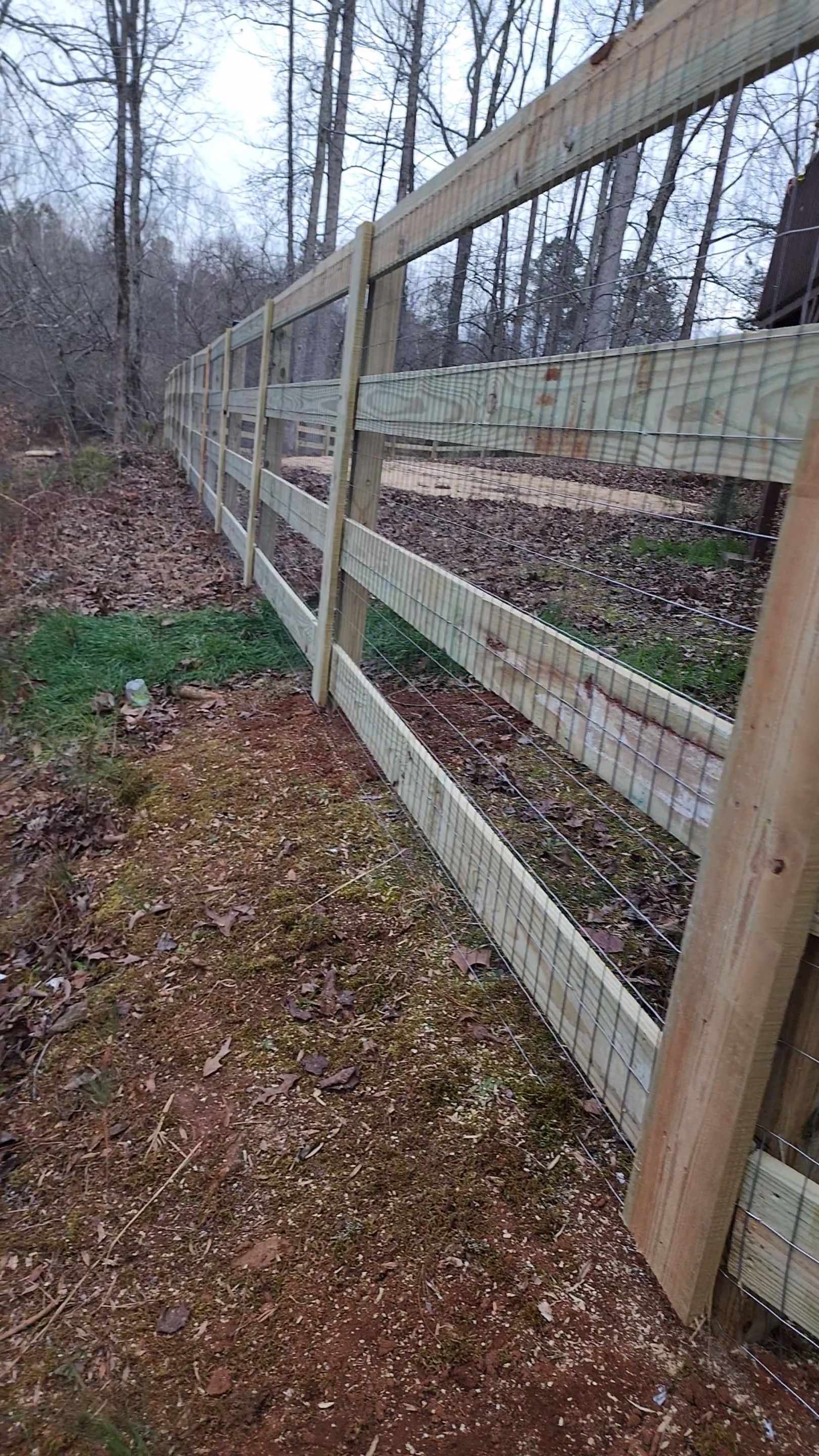 Fence Installation of 4 Rail Ranch Fence with Welded Wire by Titans of Timber Fence & Stain