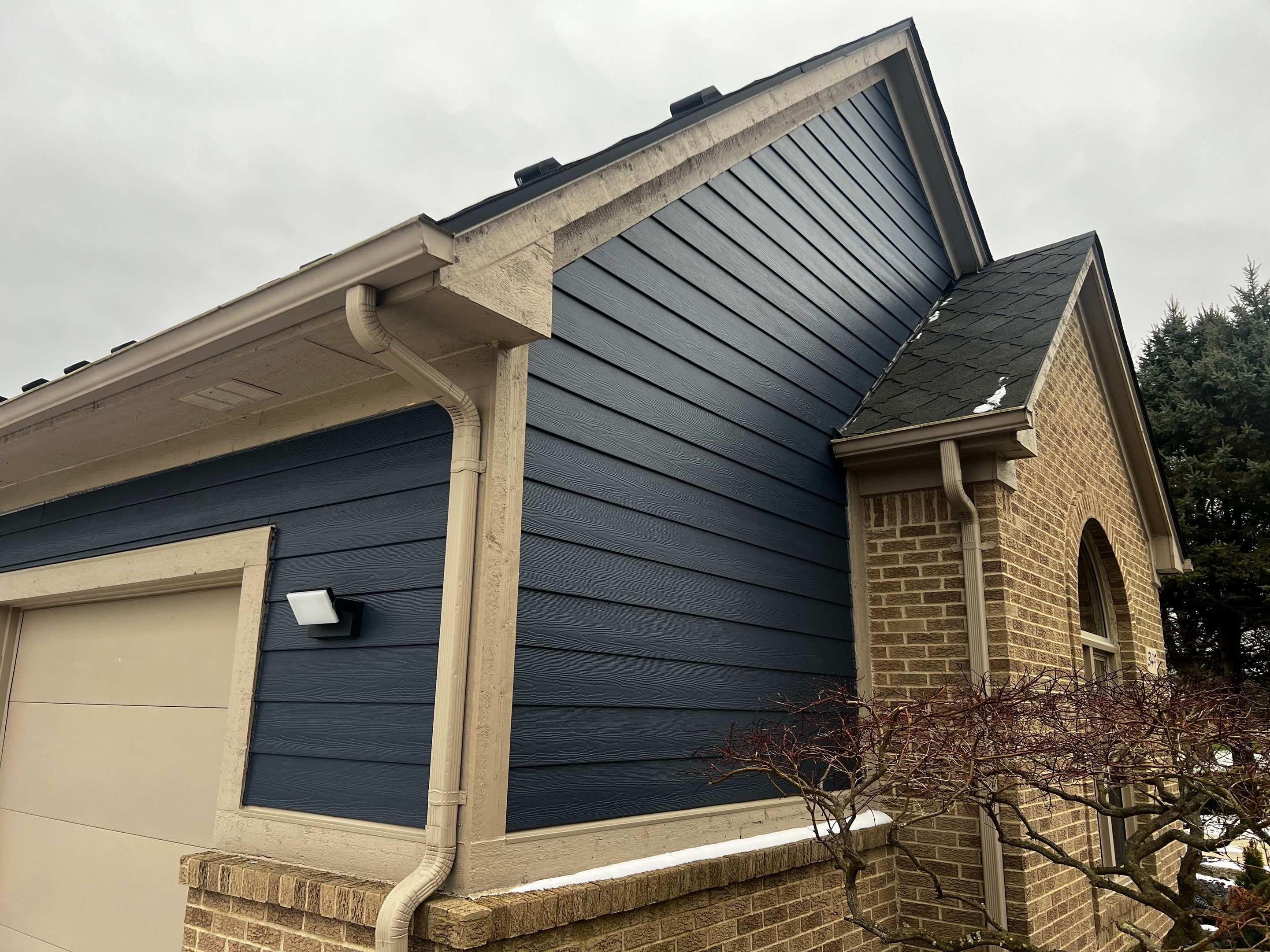 Siding Replacement using James HardiePlank Cedarmill in Deep Ocean color by Bloomfield Construction & Restoration
