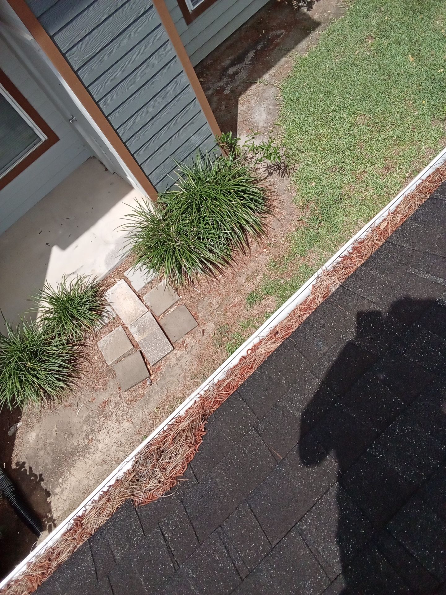 Commercial gutter cleaning Beaumont & Port Arthur before photo with filled gutters