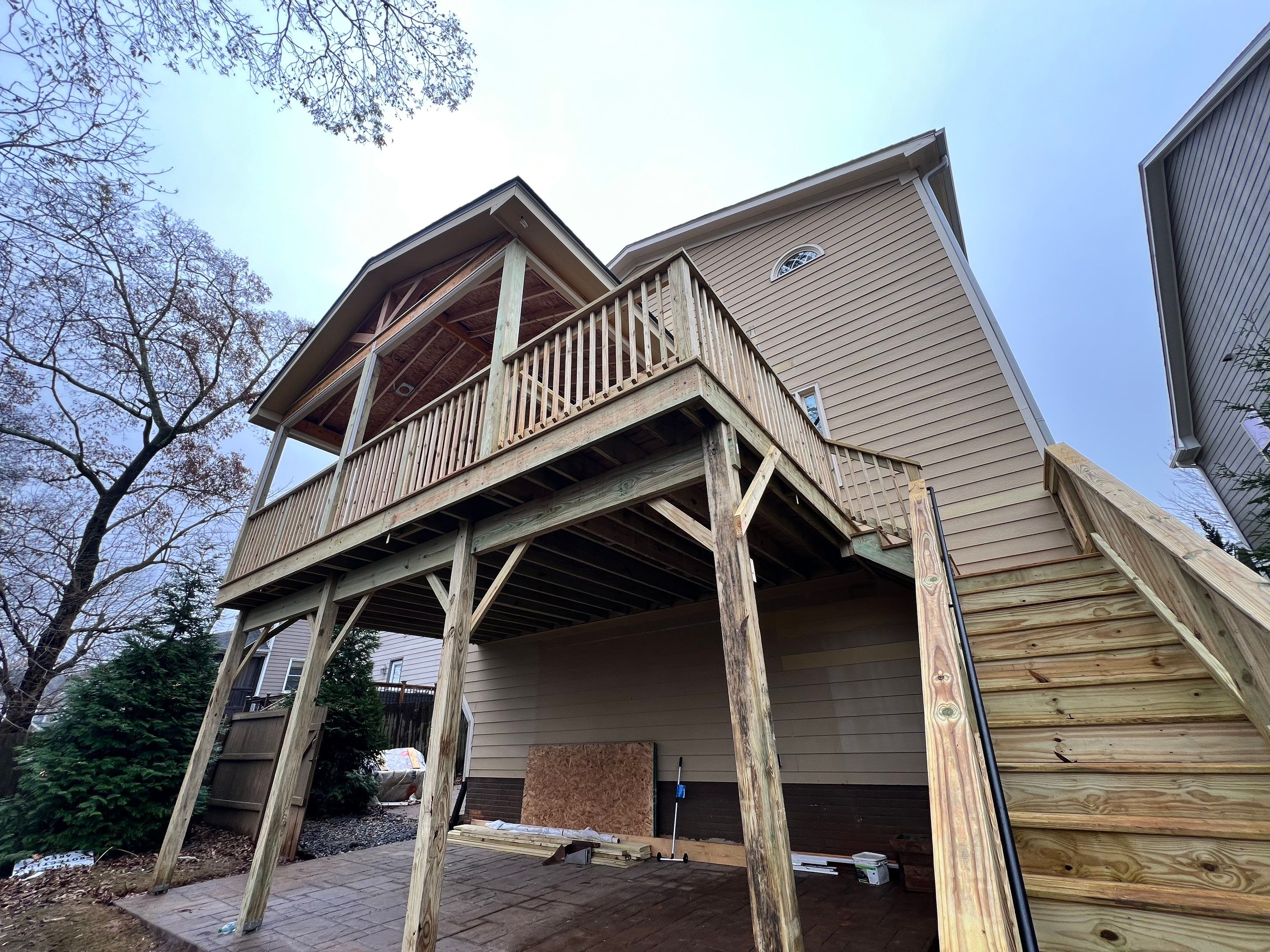 Screened-In Porch With Fireplace by Swift Home Renovations