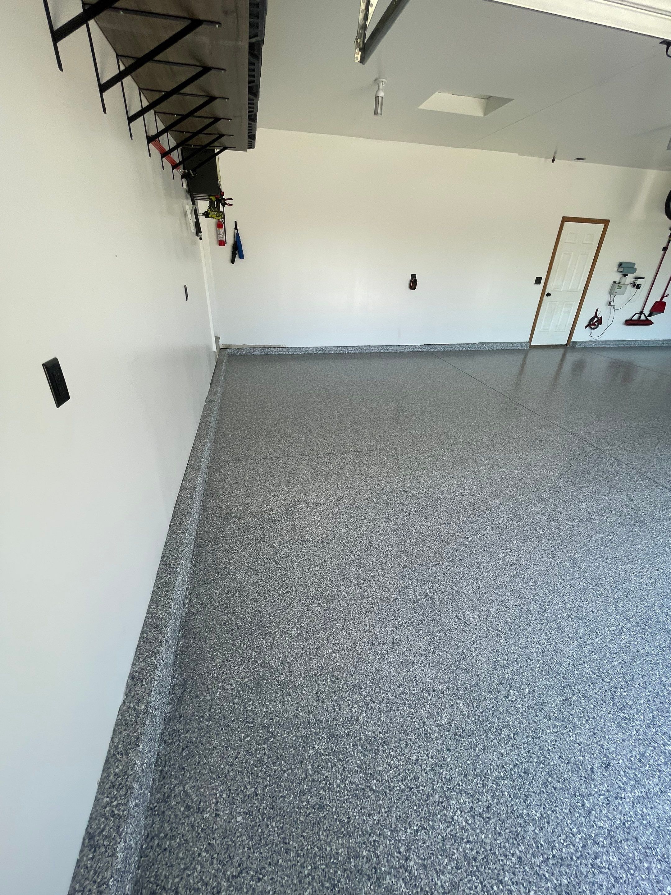 Tidal Wave Flake Garage Floor Installation in Sioux Falls by Select Painting, Coatings & Garage Cabinets