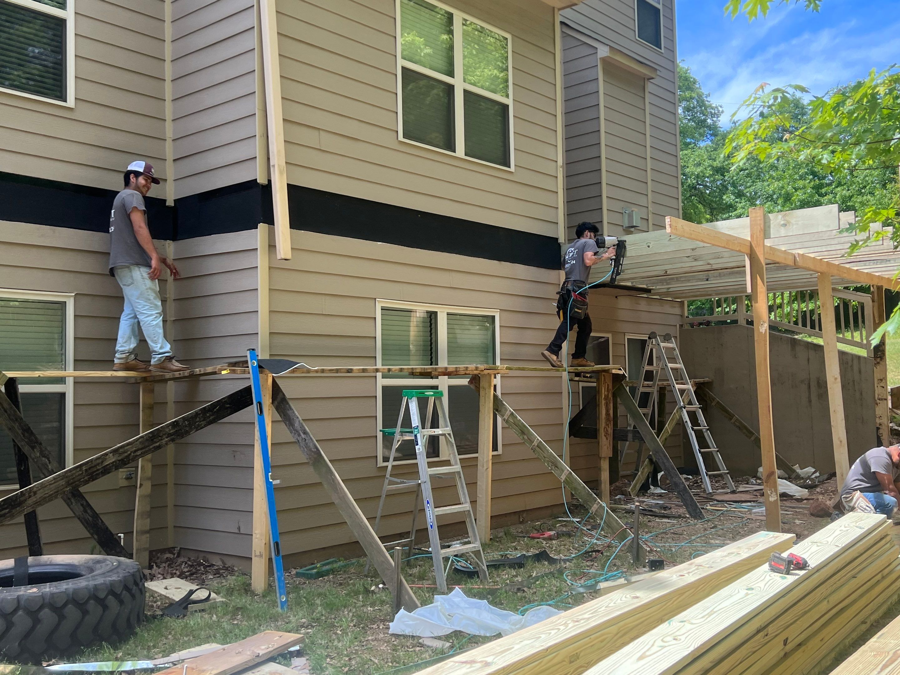 Custom Elevated Deck Replacement with White and Black Railings by Swift Home Renovations