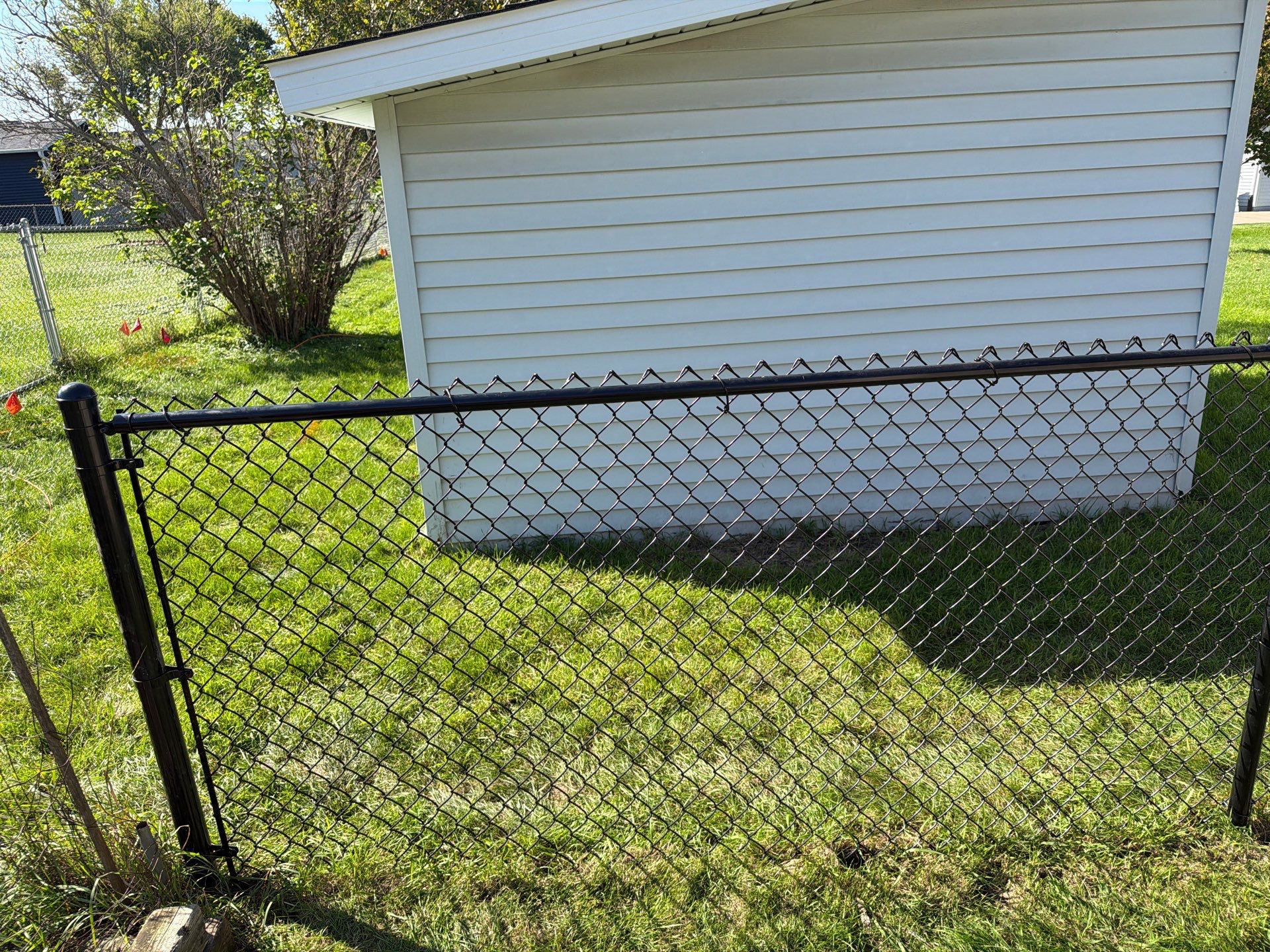 Custom Vinyl Privacy and Black Chain Link Fence Installation in Cedar Falls by Perfect Picket Fence and Stain