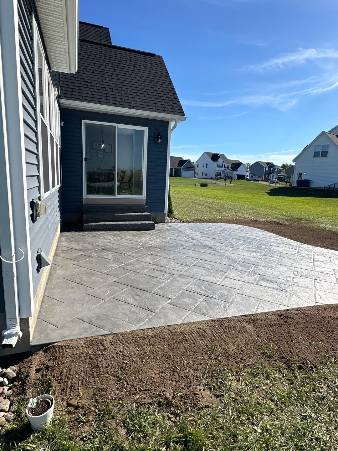 Majestic Ashlar stamped concrete patio with rock face steps  by NG Masonry & Construction LLC