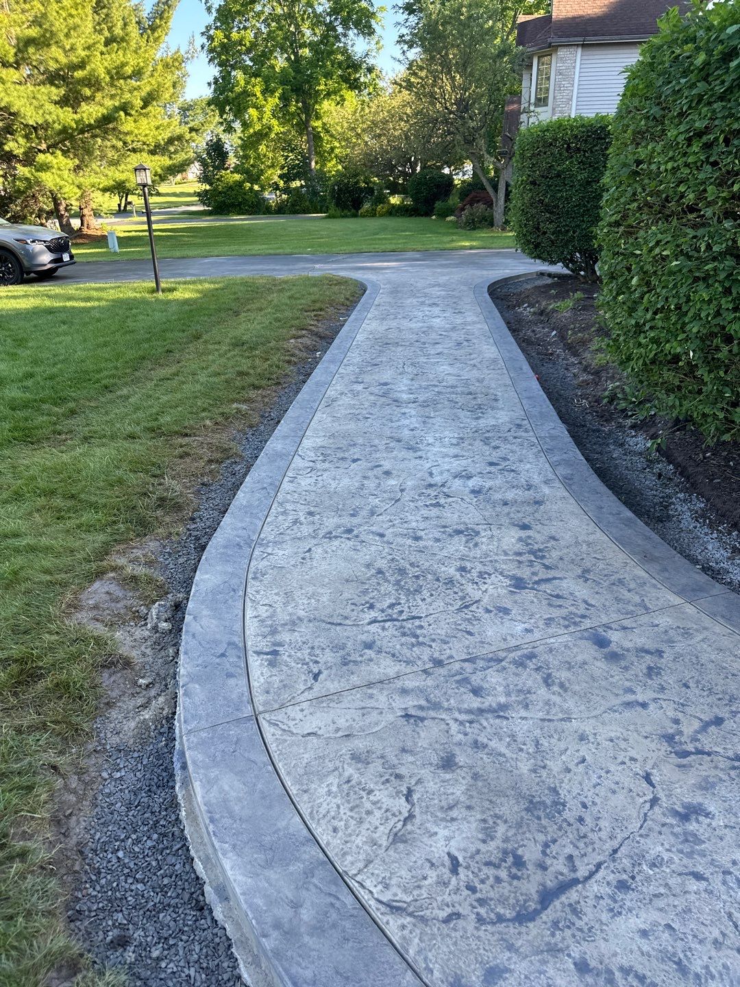 Heavy stone stamped concrete patio and sidewalk  by NG Masonry & Construction LLC