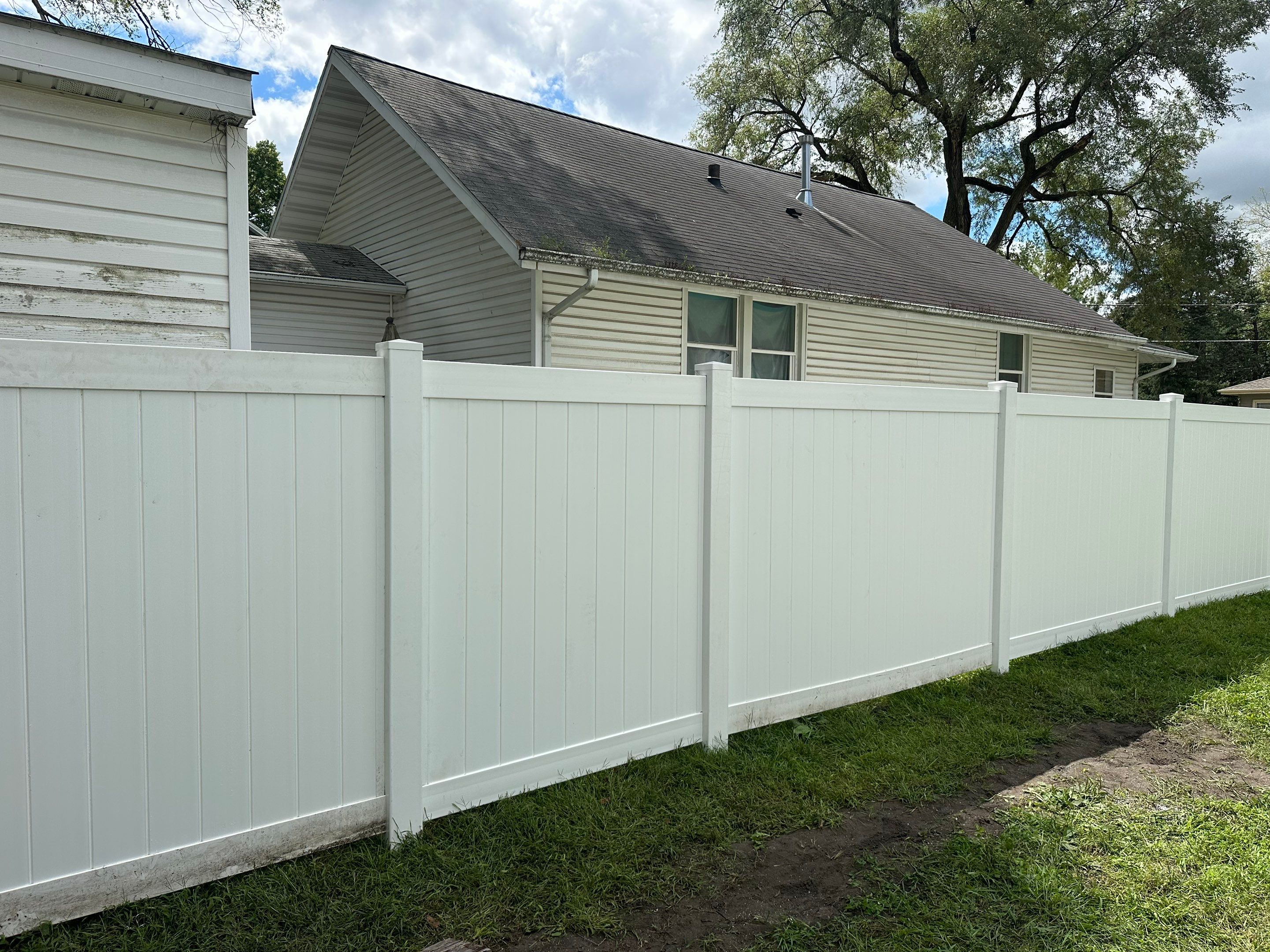 Residential White Vinyl Privacy Fence Installation in Waterloo, Iowa by Perfect Picket Fence and Stain
