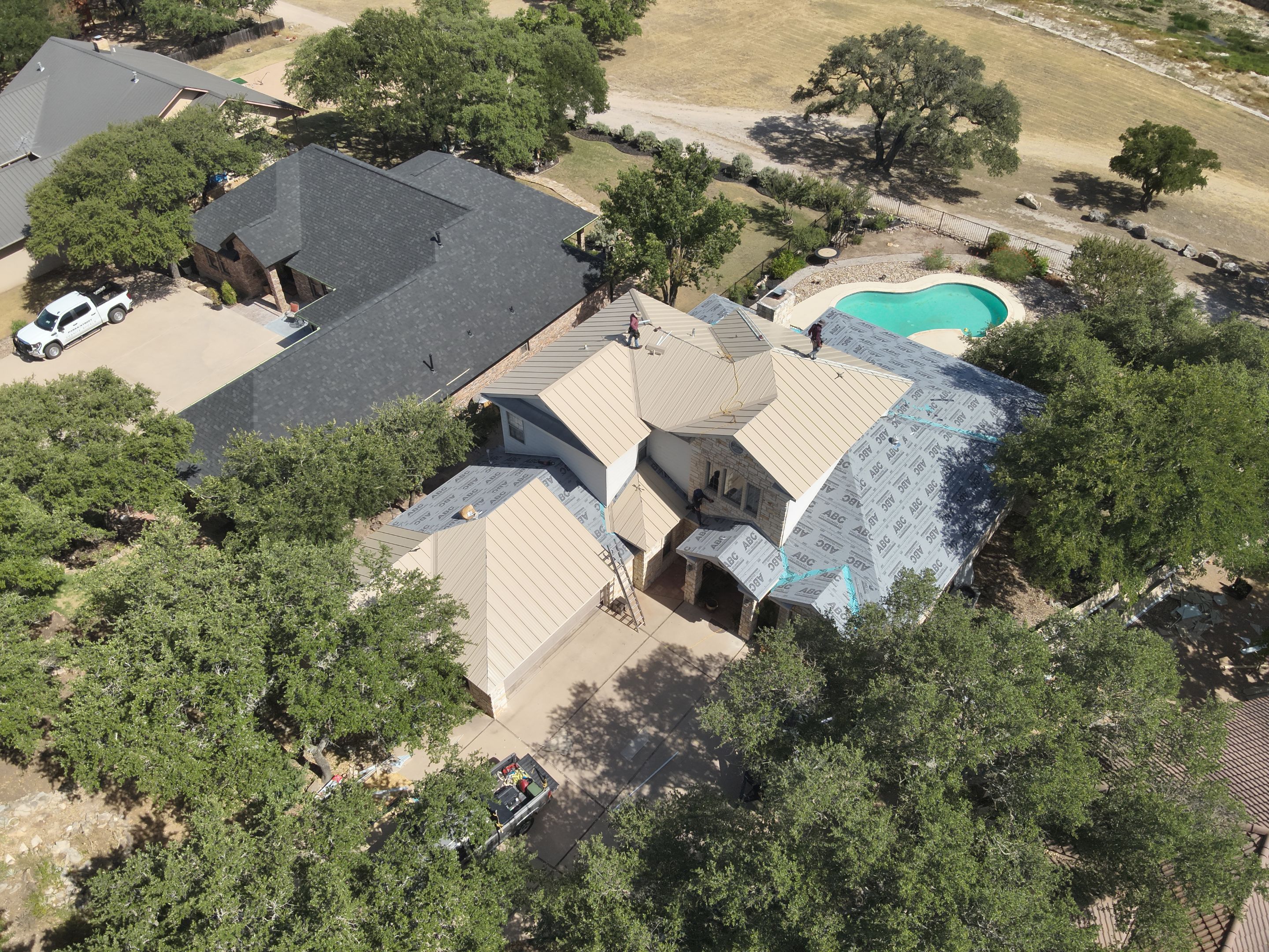 Residential Roof Replacement using 24 GA Double-Lock - Surrey Beige by Action Exteriors Austin