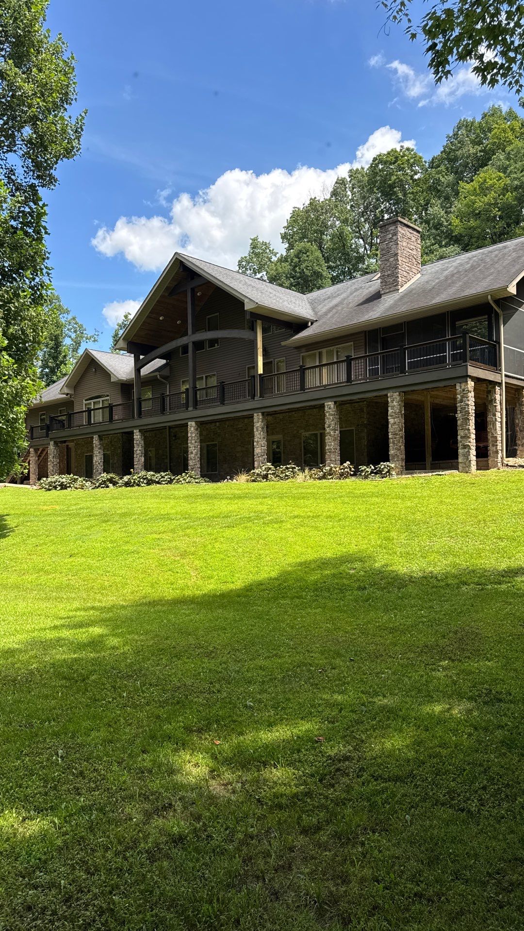 Custom Composite Deck Construction with Stone Pillars in Fayetteville by Walnut Hollow Decks & Outdoor Living